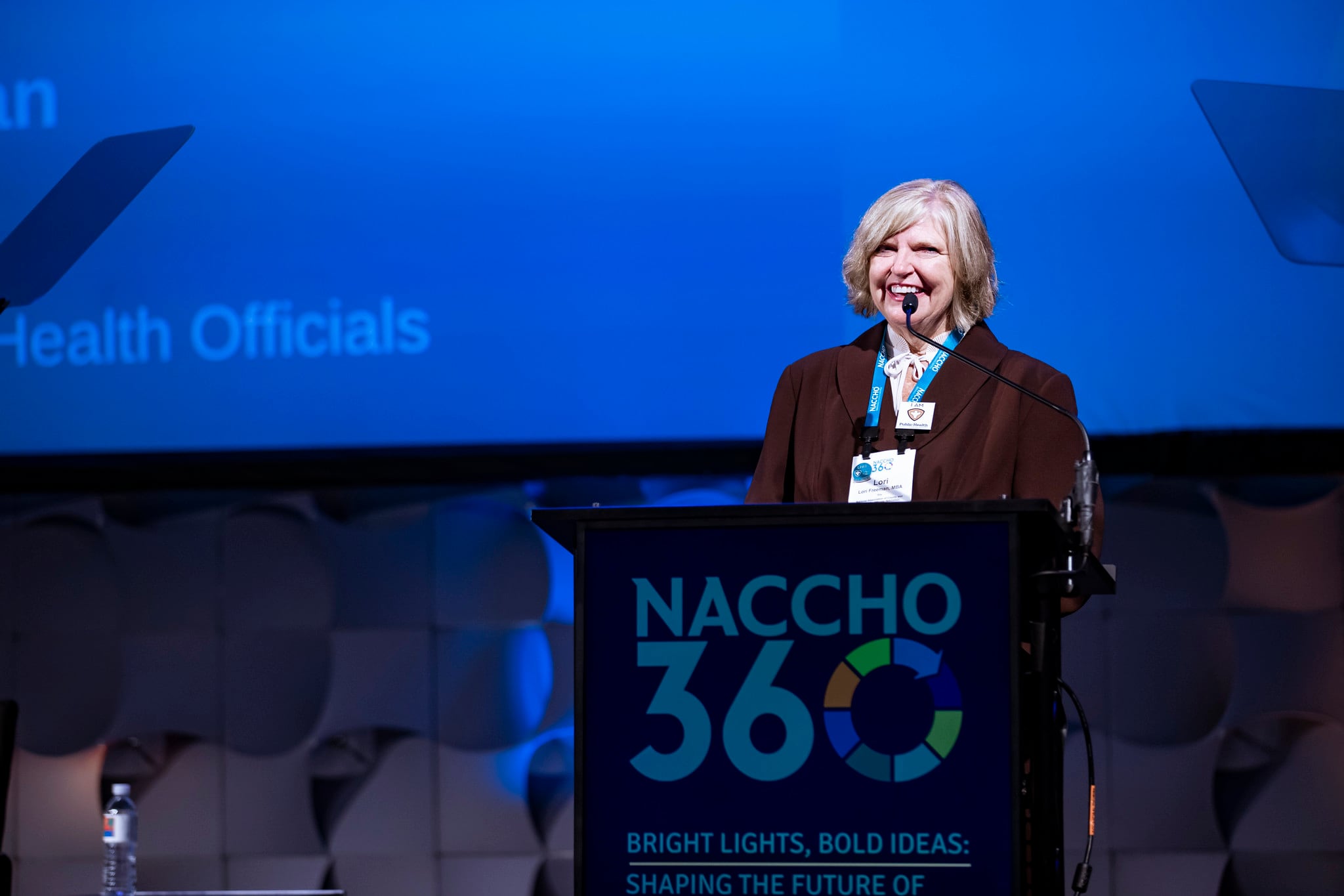 Lori Freeman stands at a podium.