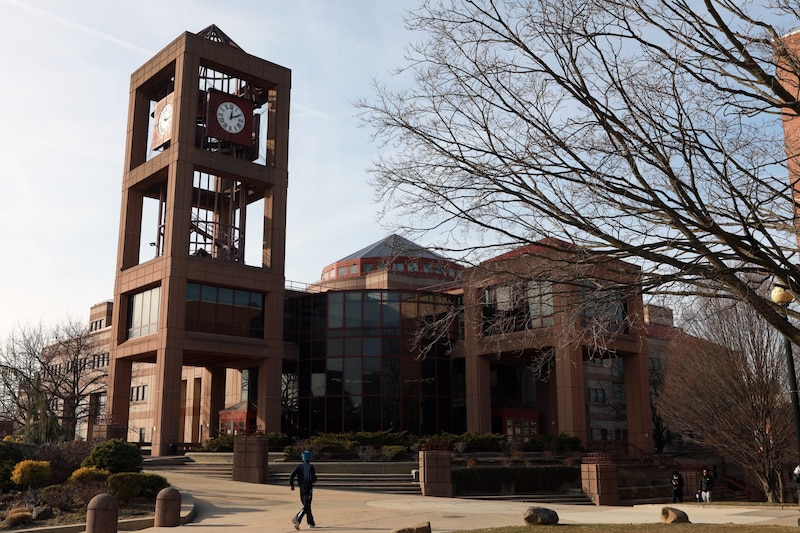 Students walk by the Benjamin Rosenthal Library at Queens College.