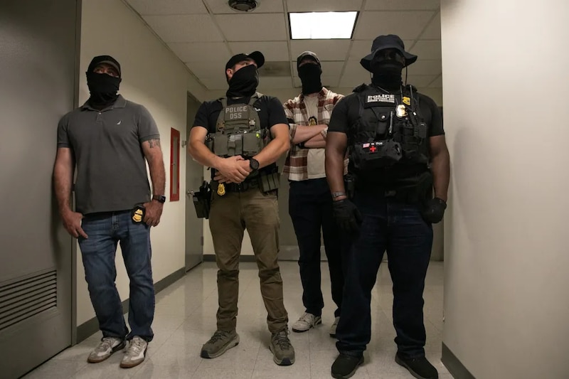Masked agents wait to detain people leaving immigration court.