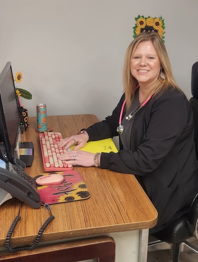 Ashely Walden works at a computer.