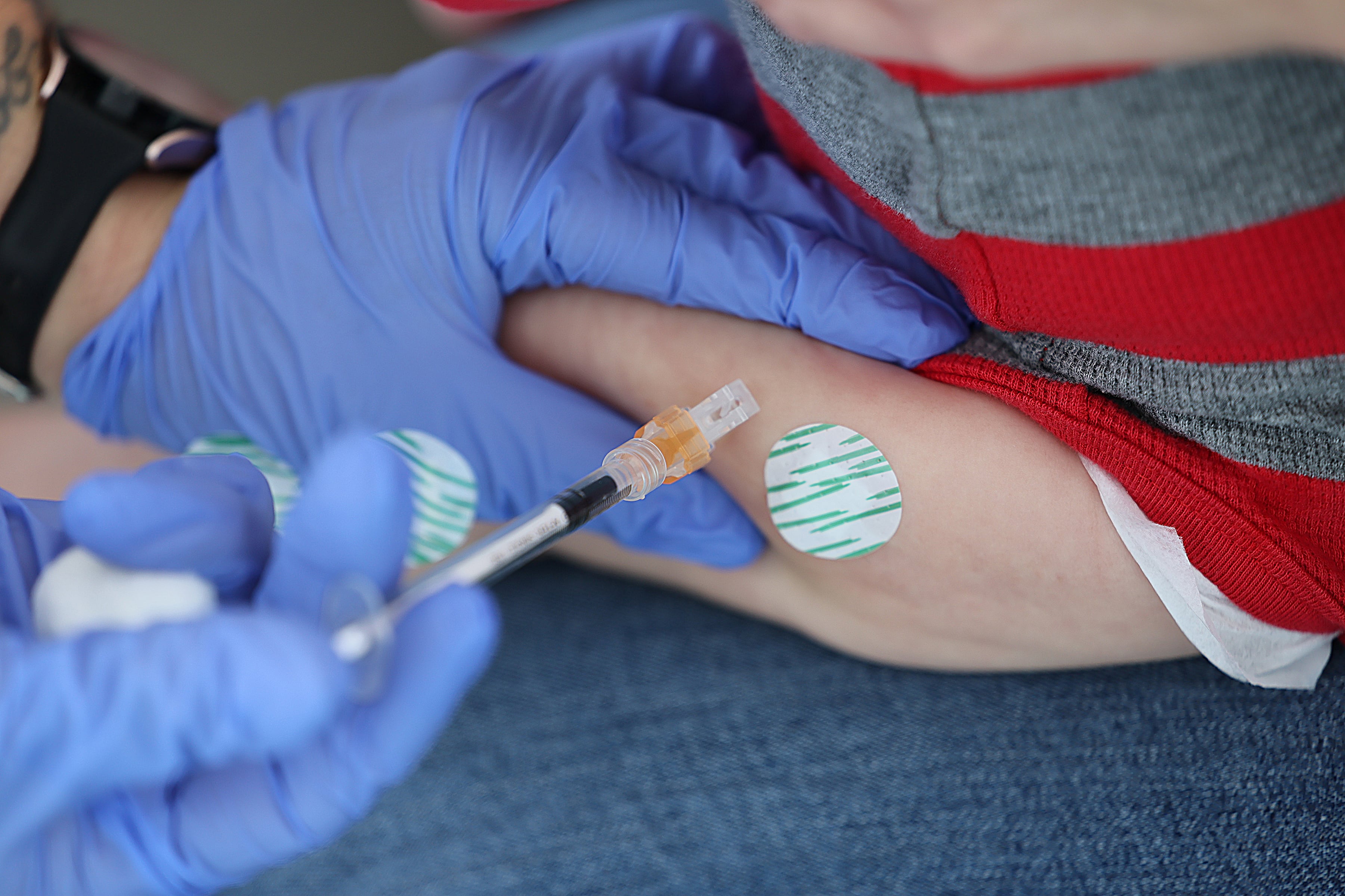 A child gets a shot in the arm.