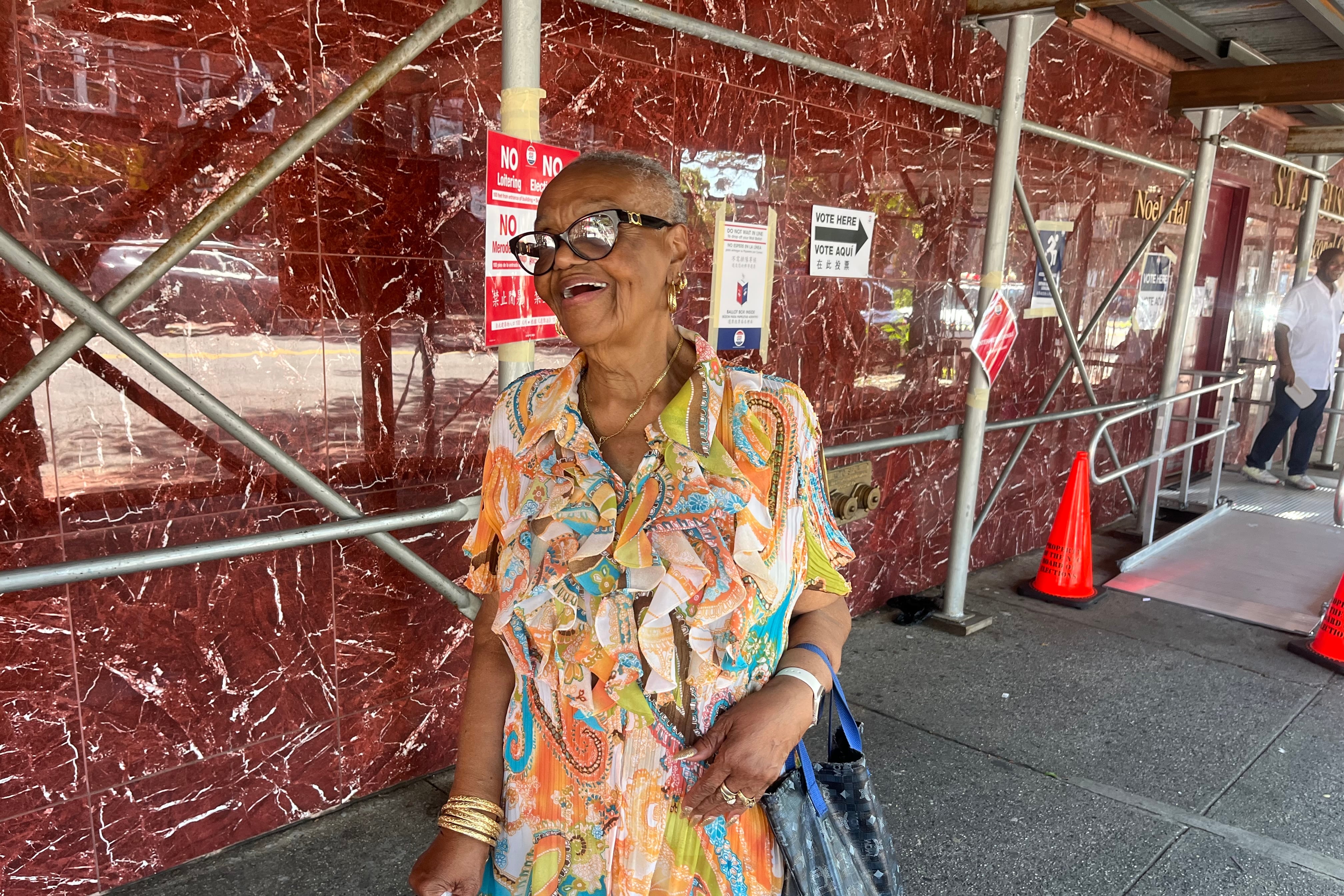 A woman stands near a polling place in New York City.