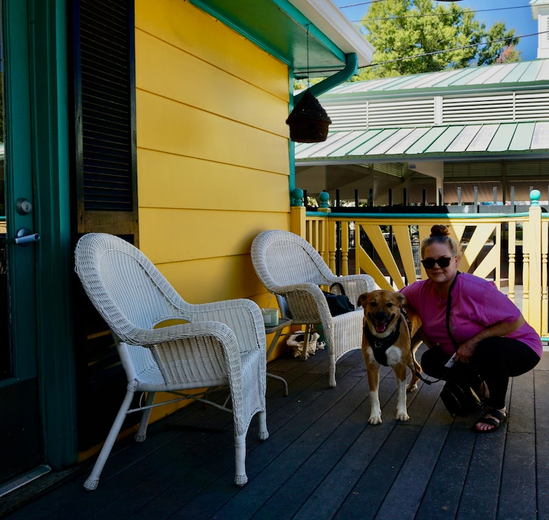 Emily Payne squats down next to her dog, Hendrix.