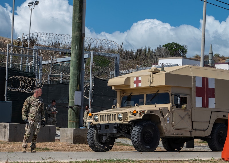 U.S. service members participate in a simulated medical evacuation of immigrants.