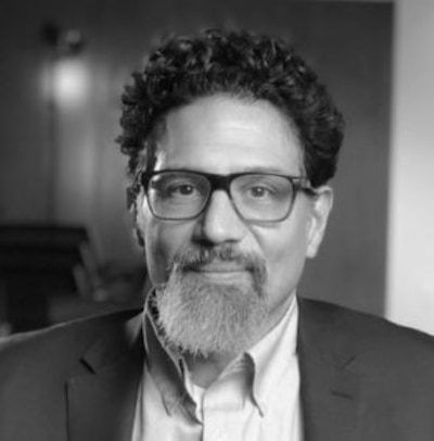 A black-and-white headshot of Dr. Denis Nash.