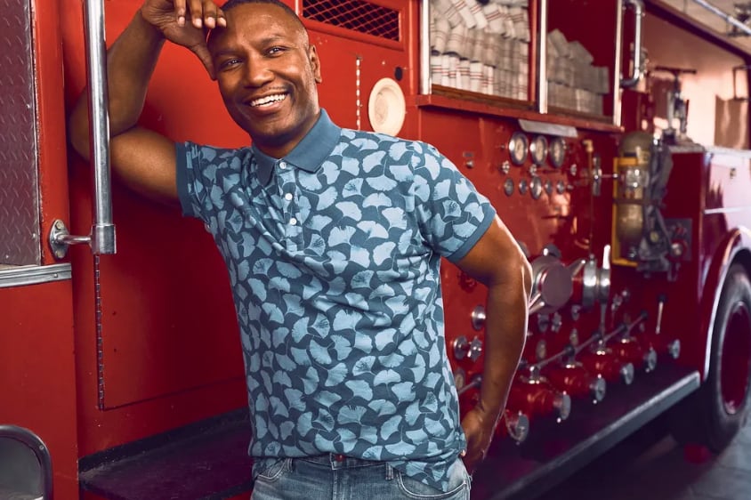 Anaré Holmes leans against a fire engine.