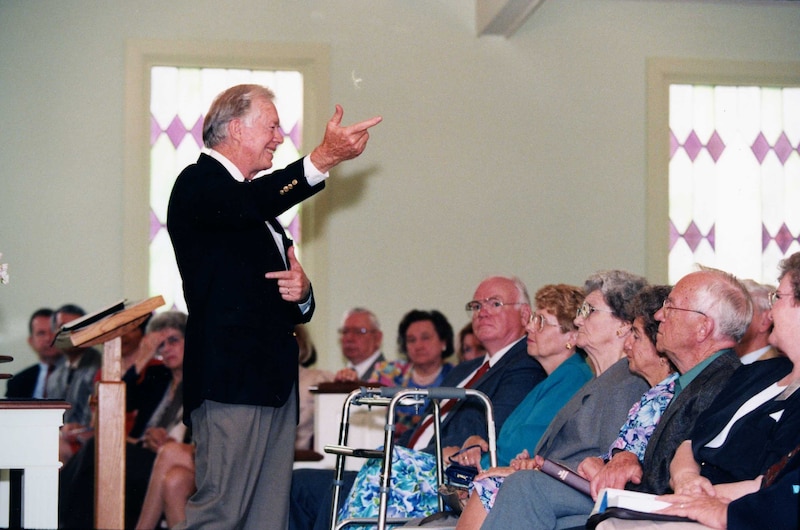 Jimmy Carter stands at the front of the room to teach a Sunday school class.