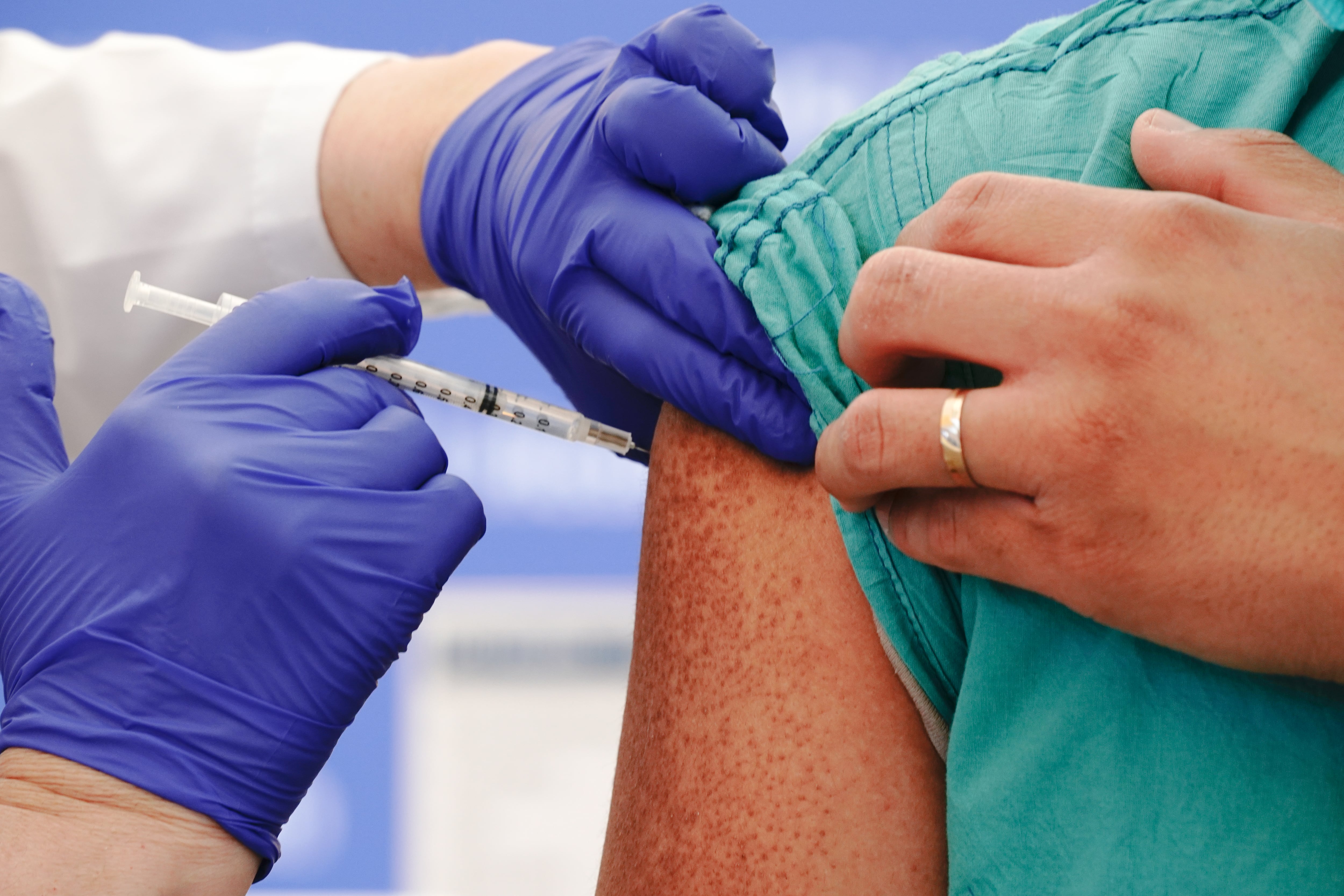A person gets a Covid shot in the arm.