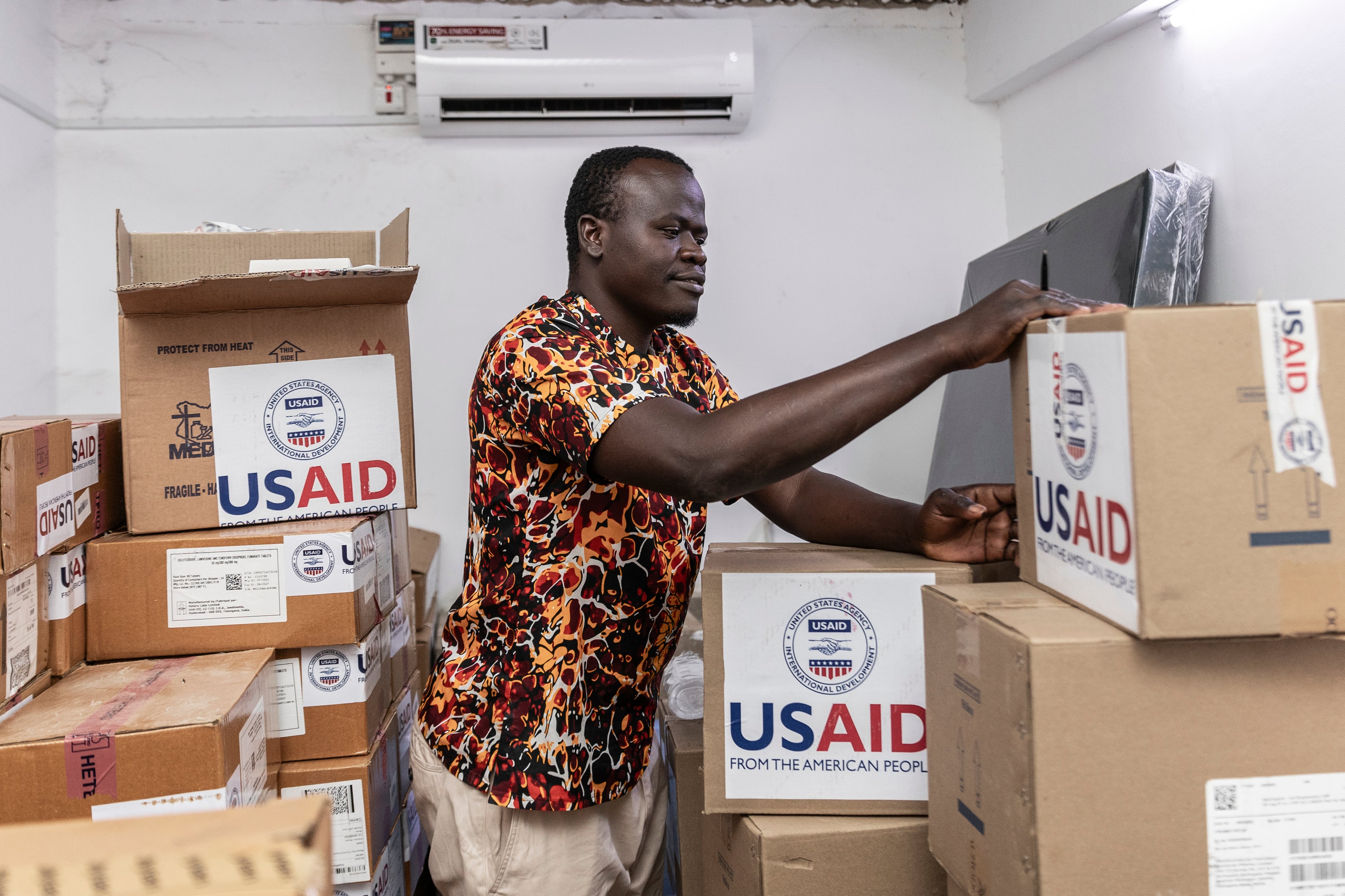 A man handles boxes marked "USAID."
