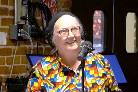 Dr. Kimbi Hagen speaks at a microphone