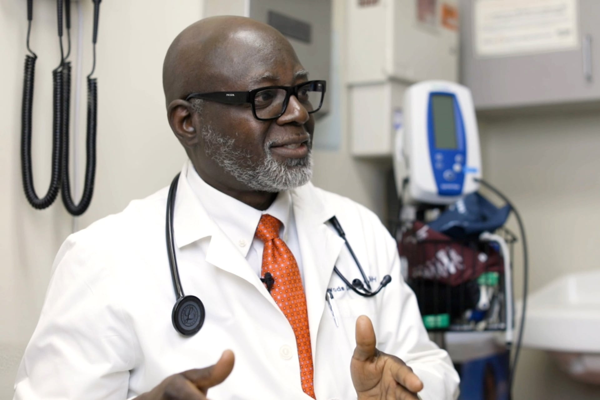 Dr. Alawode Oladele stands in a medical exam room.