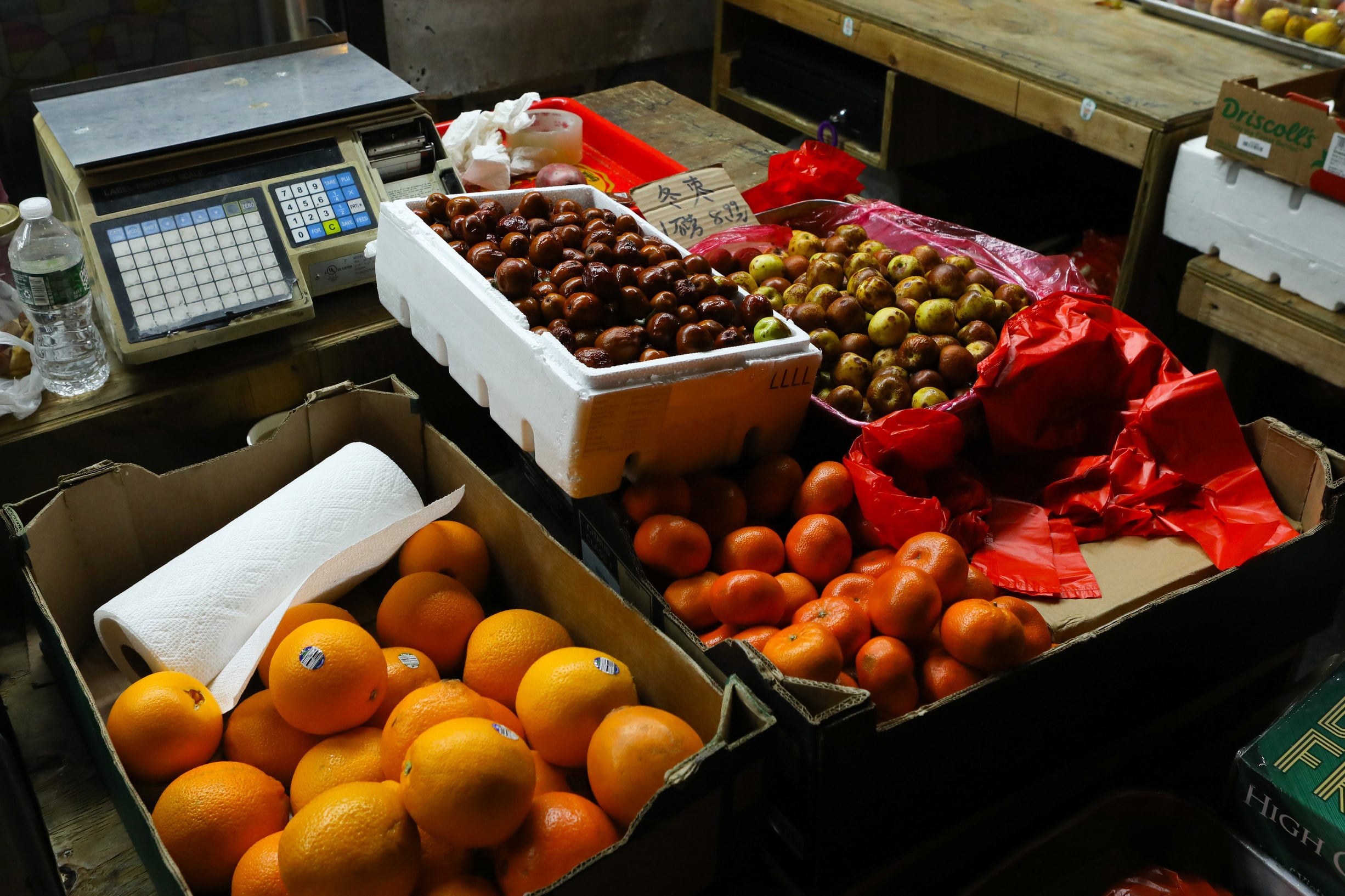 Bins of oranges and other produce are on display from a street vendor in Chinatown.
