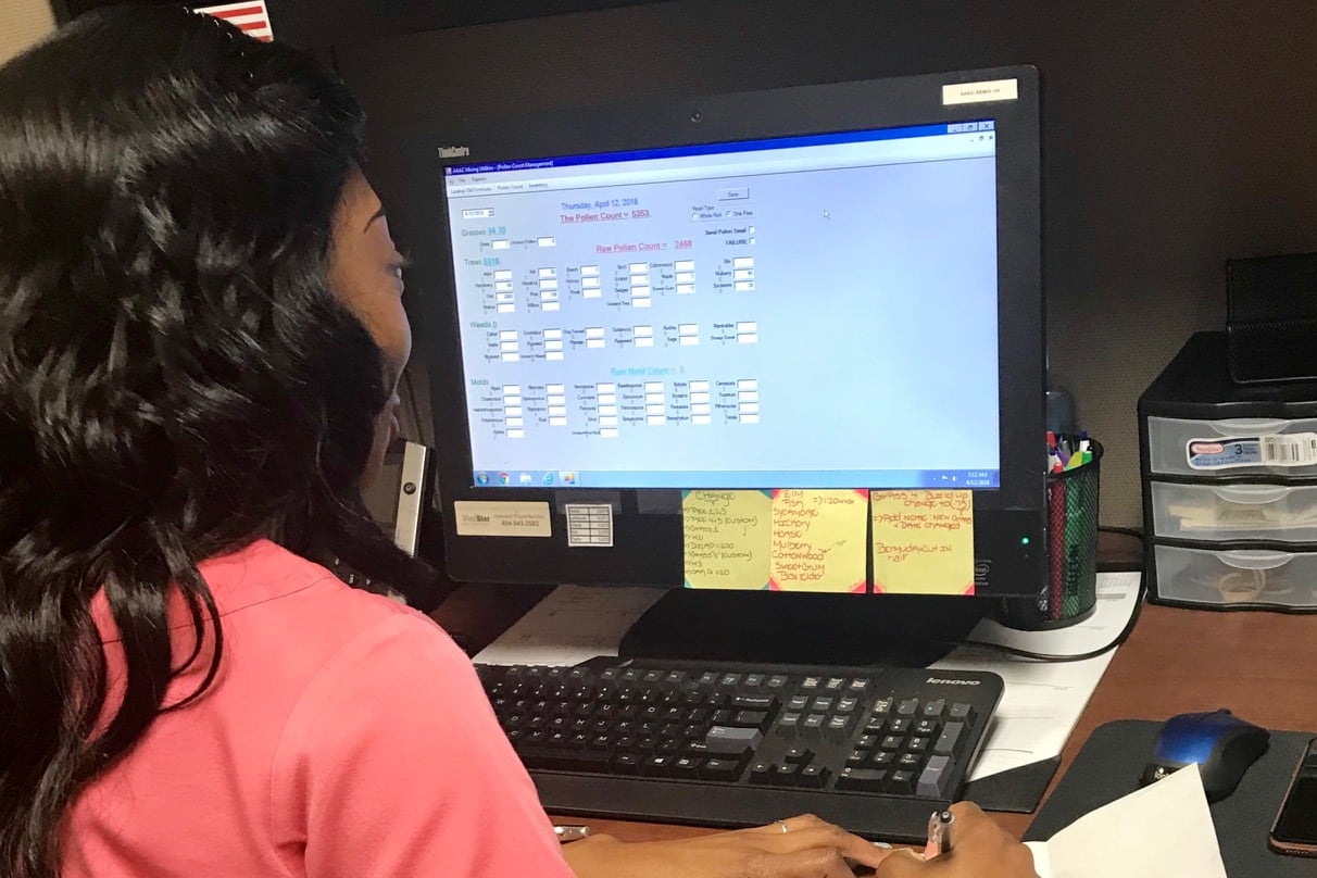 A woman works at a computer.