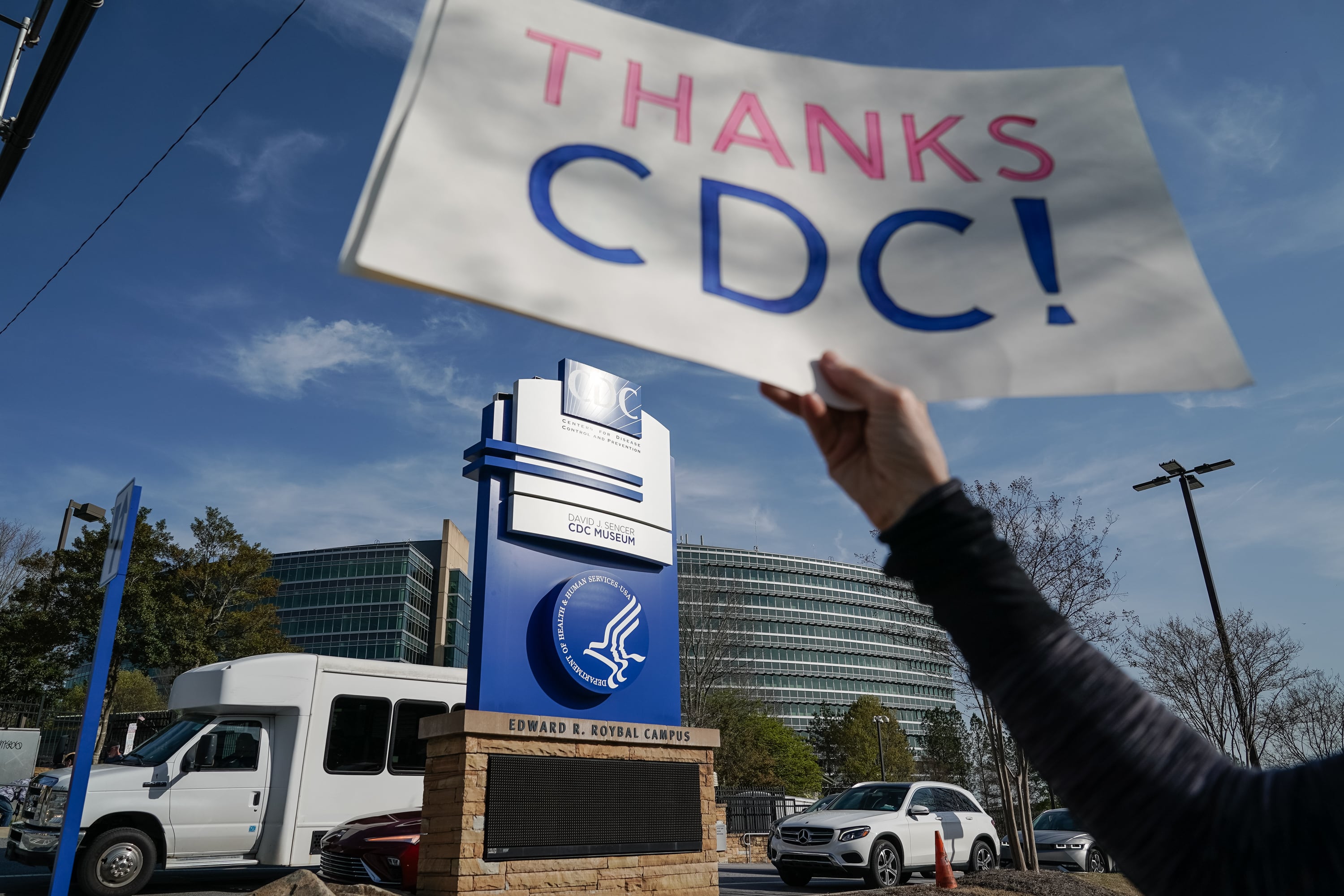 A demonstrator holds a sign that reads "Thanks CDC!" outside the agency's Atlanta headquarters.
