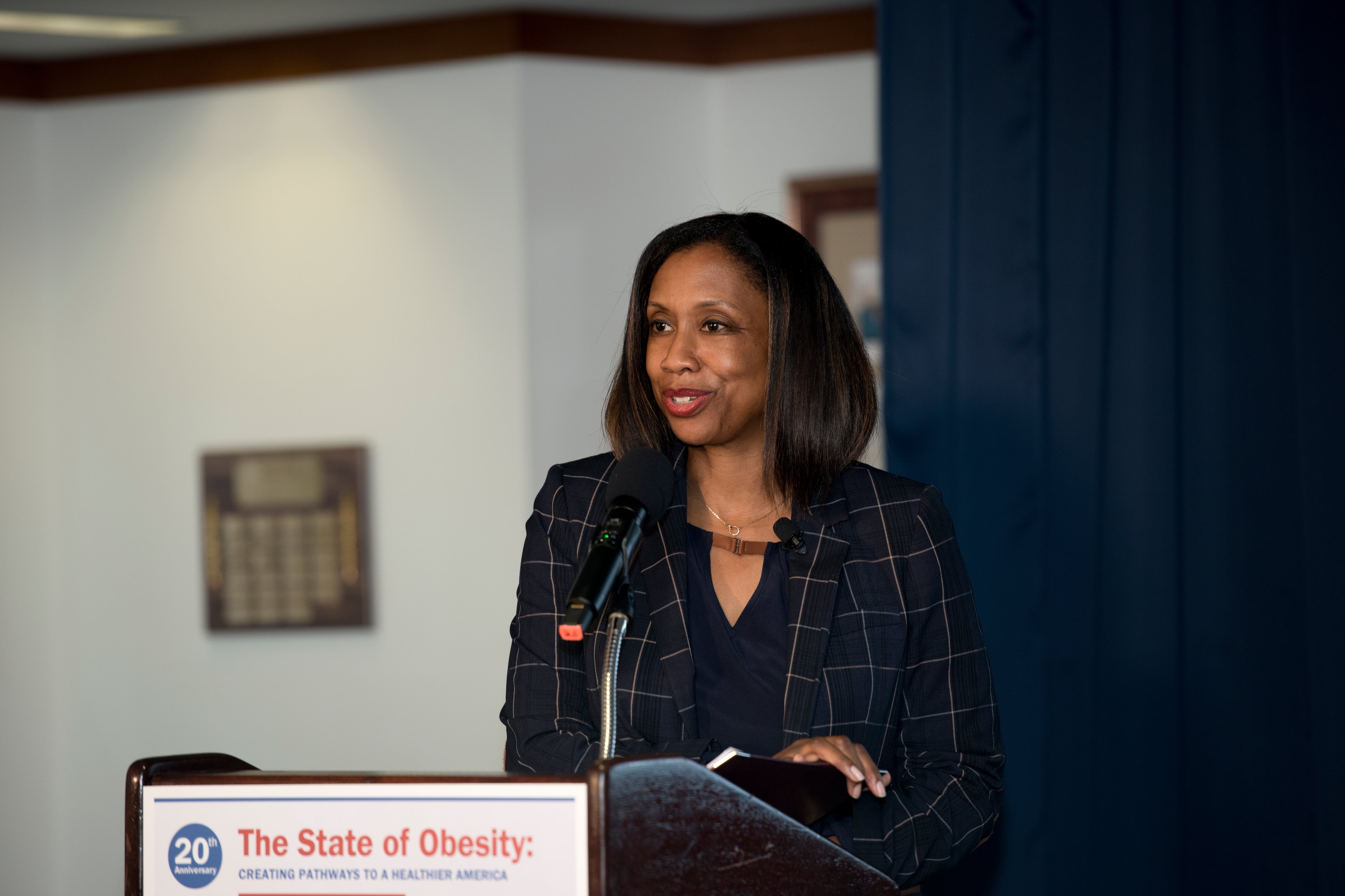 Dr. J. Nadine Gracia stands at a podium.