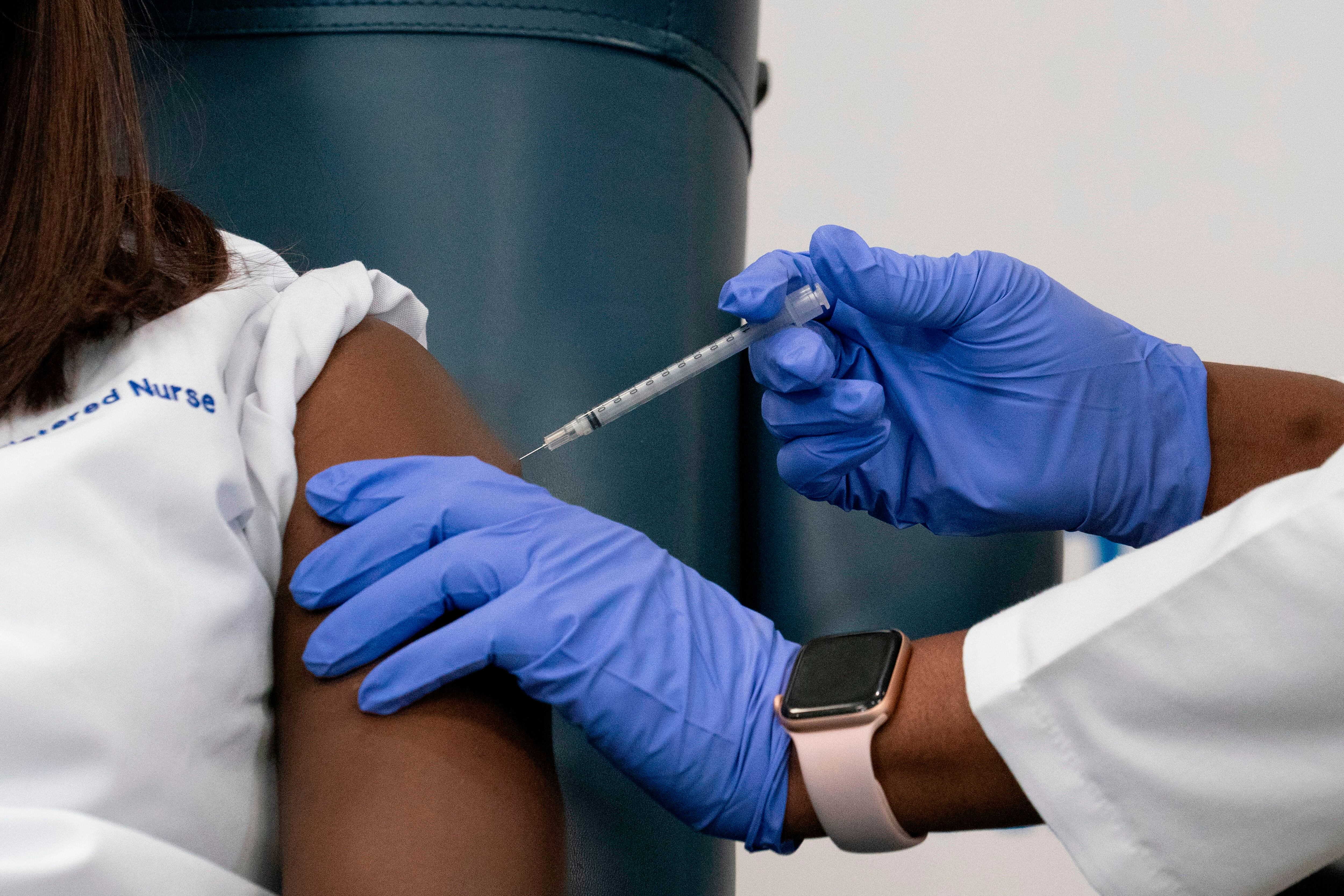 A nurse gets a Covid vaccine shot in the arm.