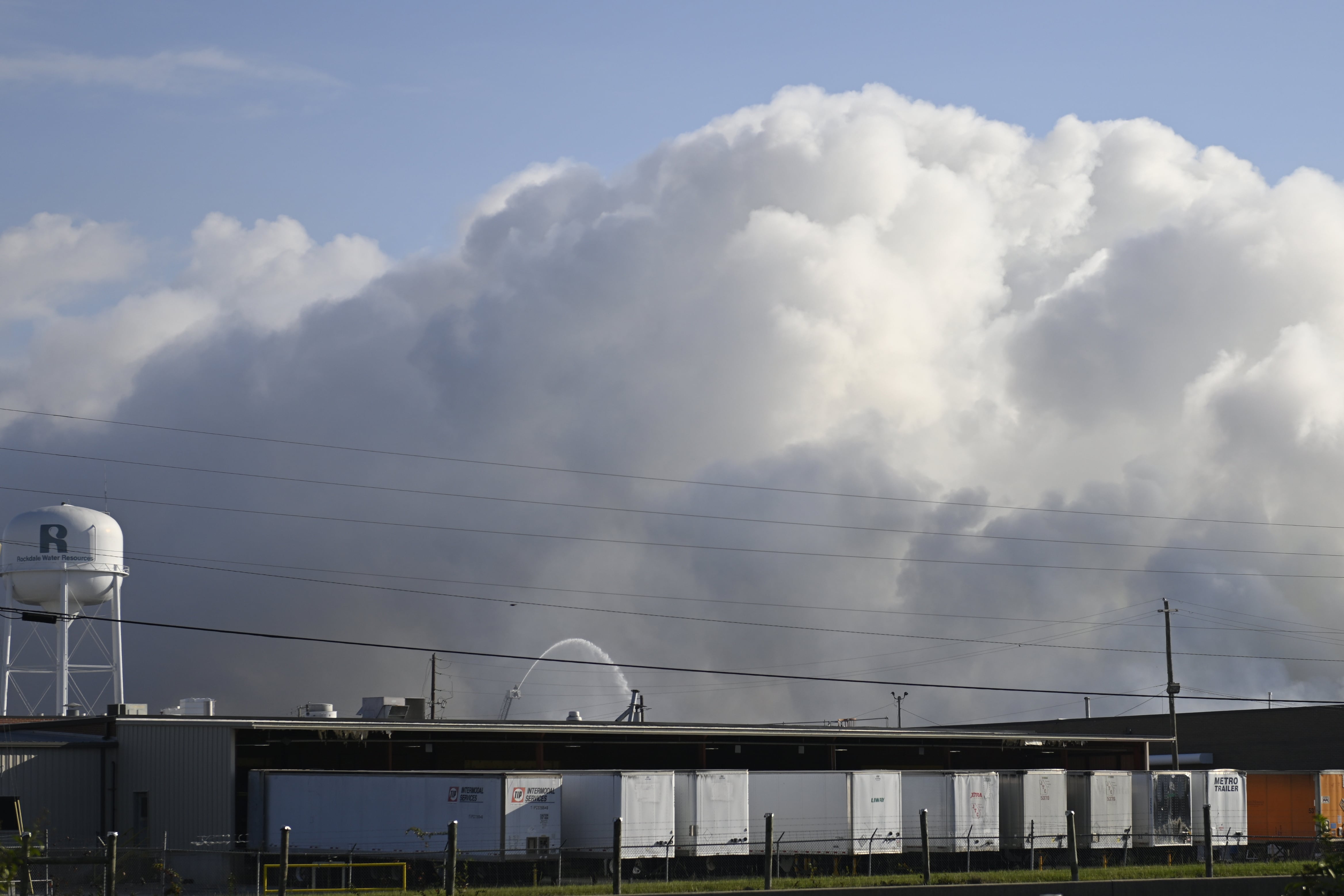 A huge plume of smoke rises over the BioLab chemical plant.