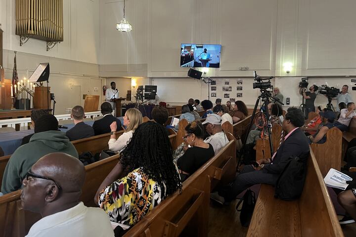 Harlem residents gather at a church for a meeting.