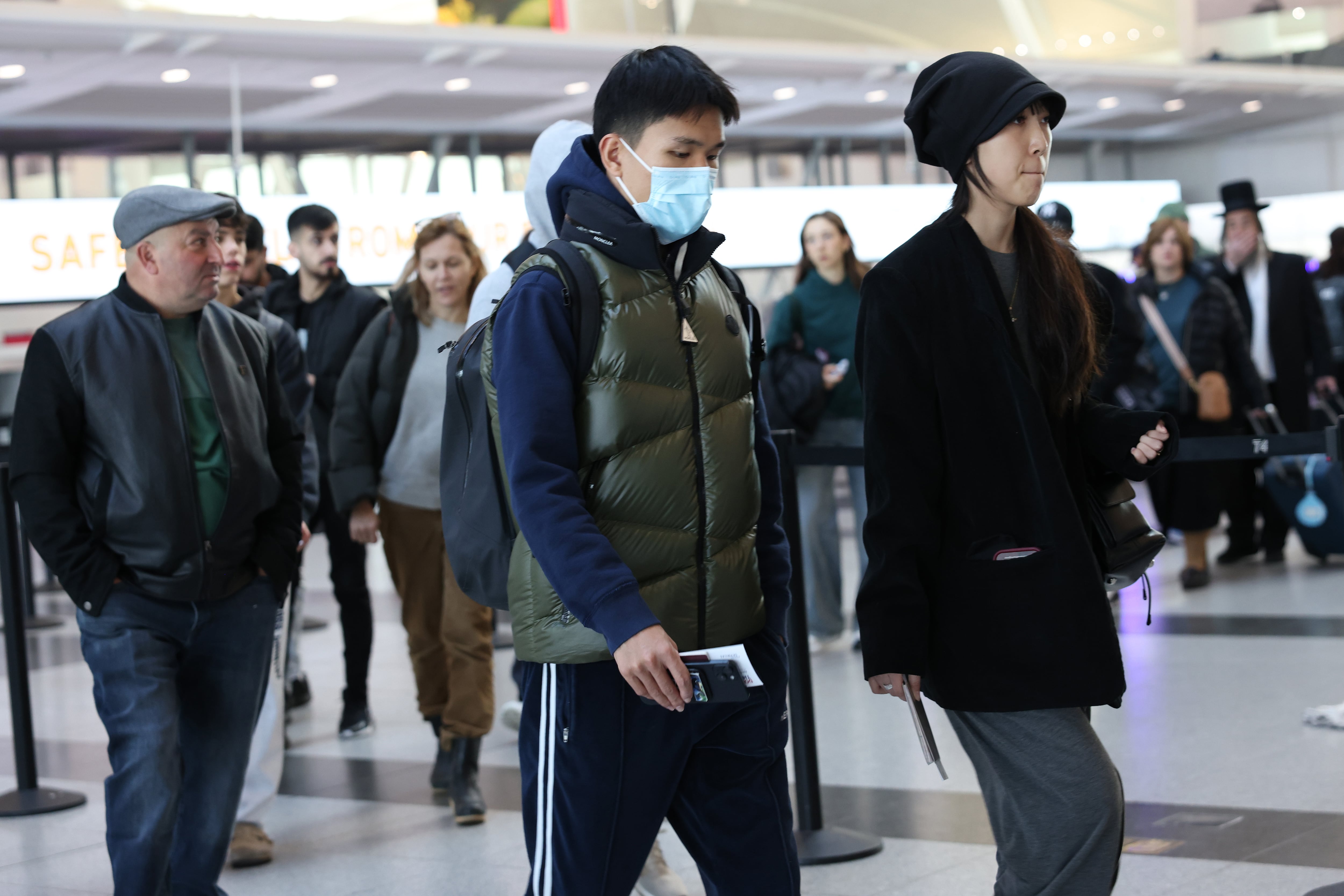 Travelers walk through the airport.