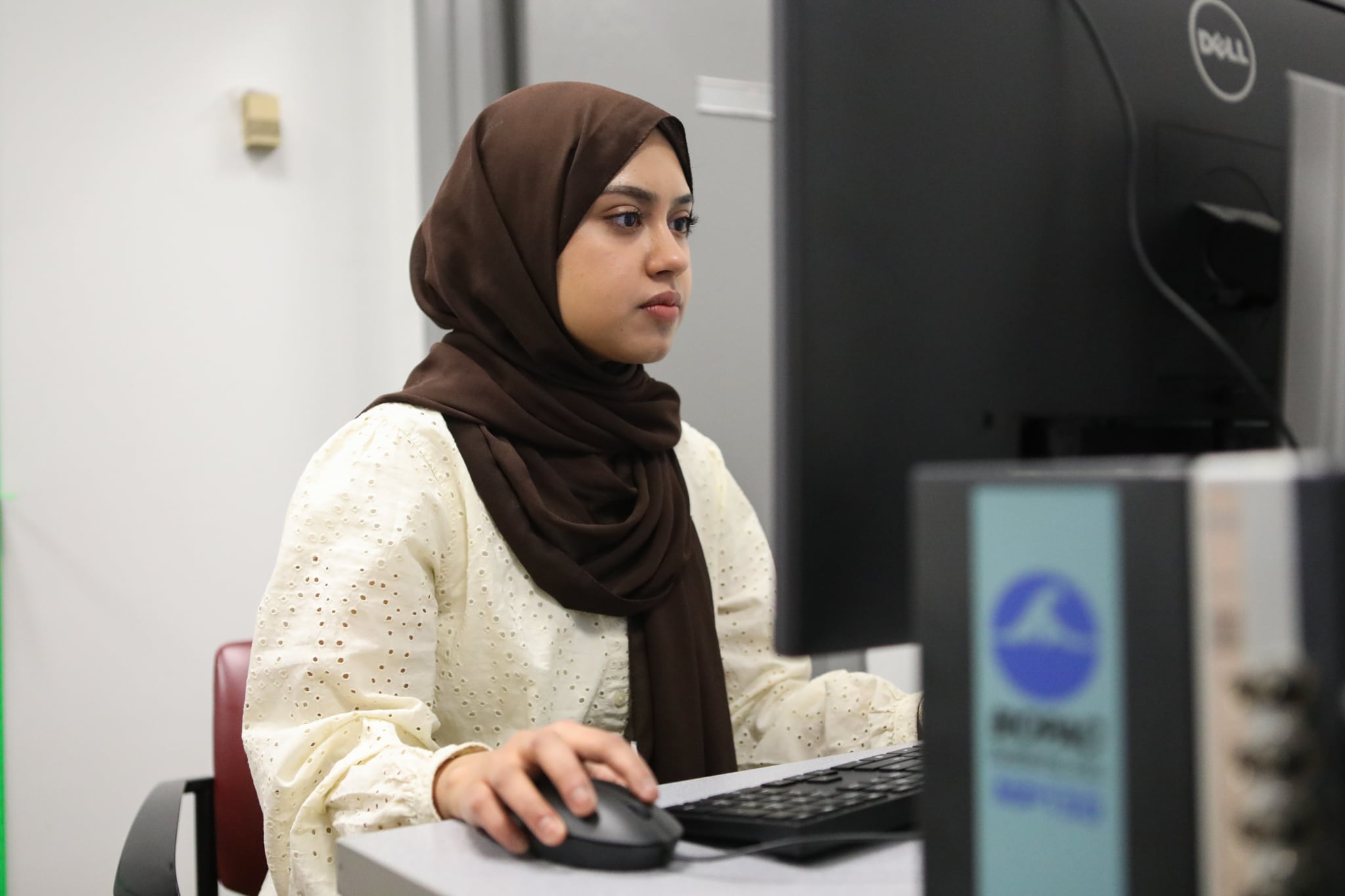 Queens College neuroscience student Labiba Aziz works at a computer.