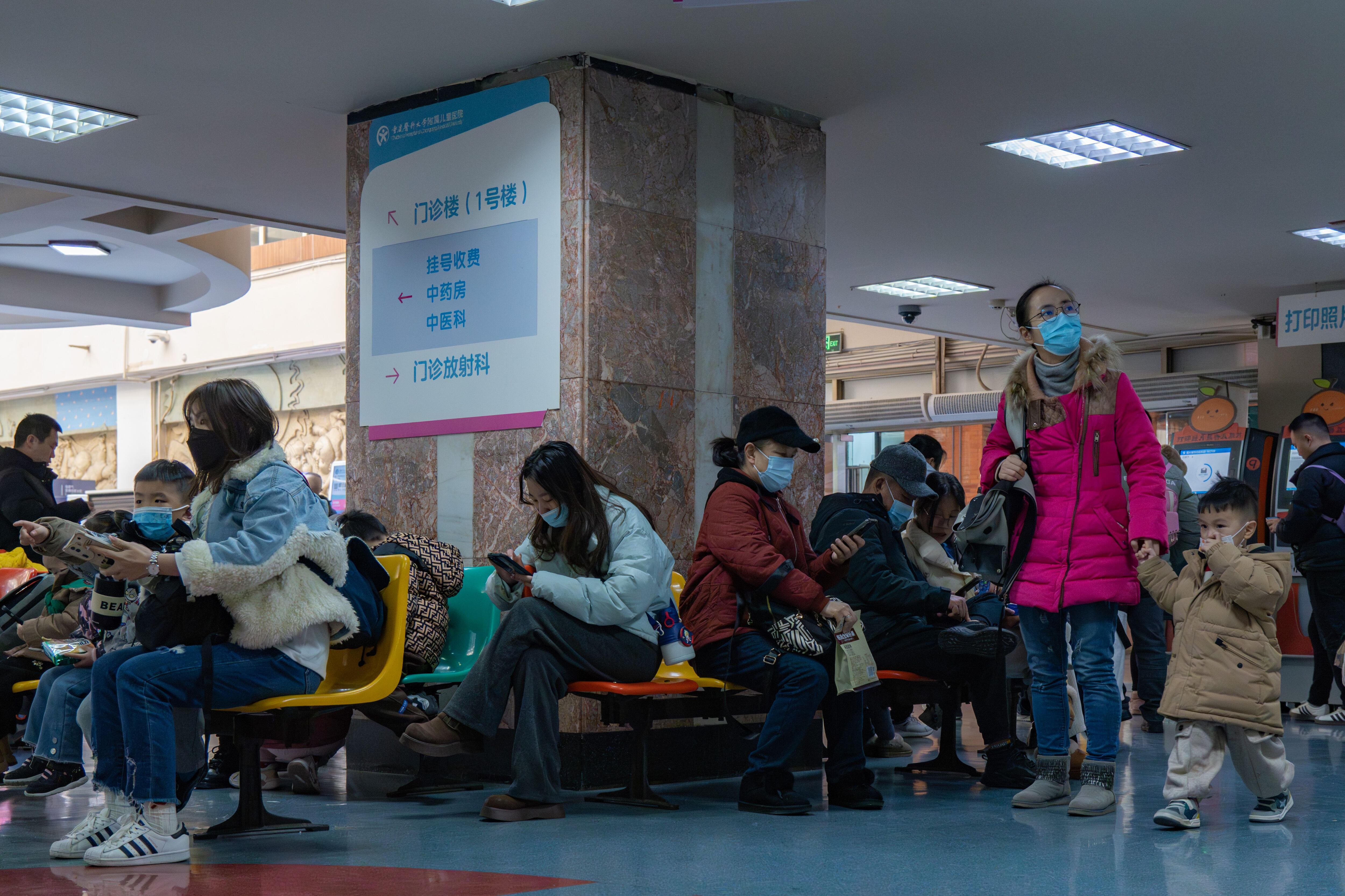 People wearing masks wait to see a doctor in China.