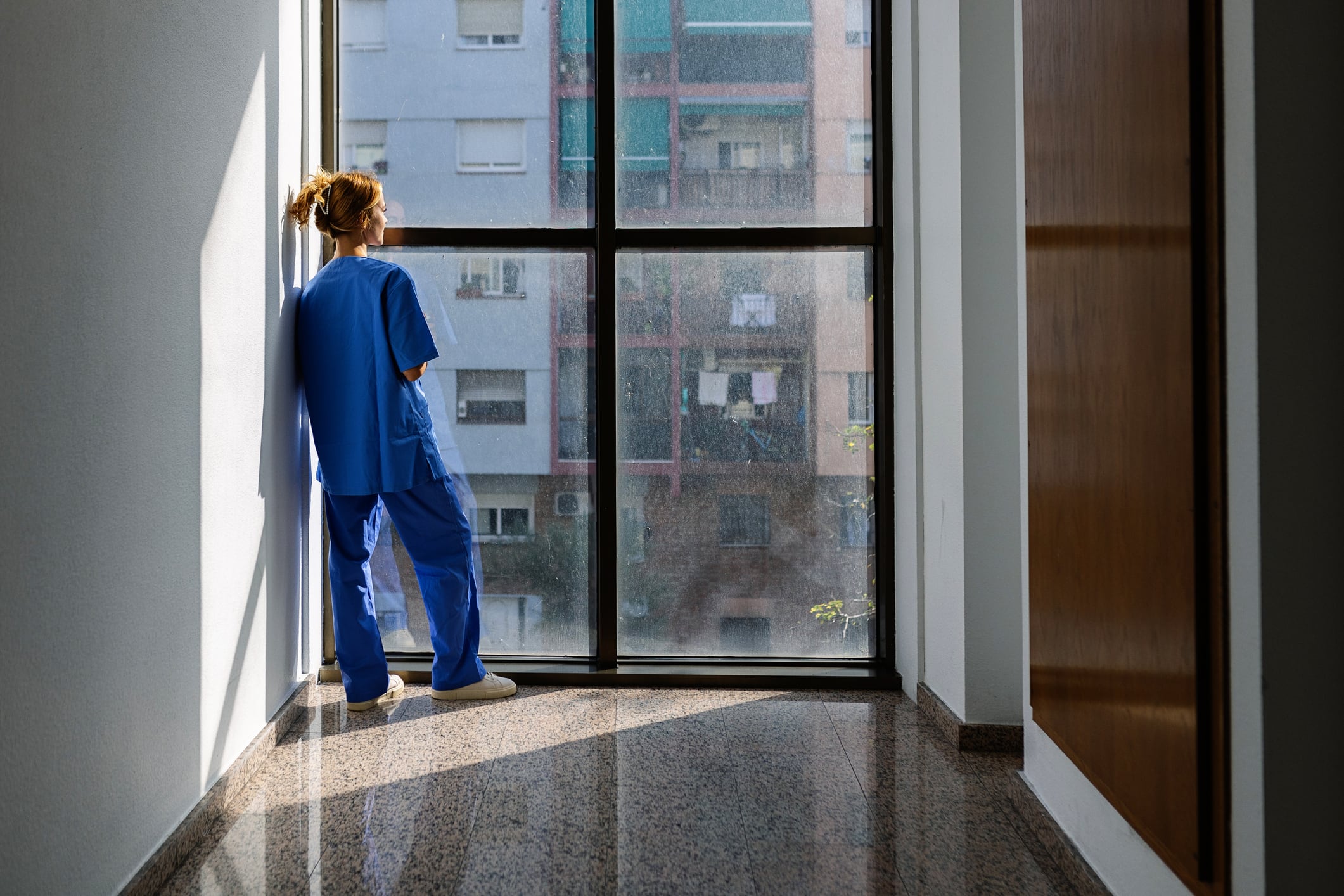 Young female healthcare worker in scrubs at the hospital.