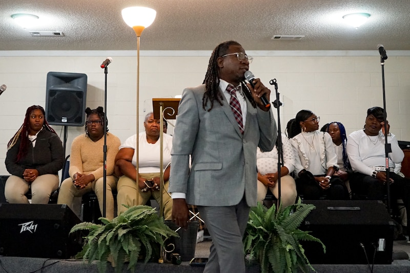 Pastor Jerry Shelton speaks into a microphone during a sermon at the Anointed Oasis of Love Ministry church in the Mississippi Delta.