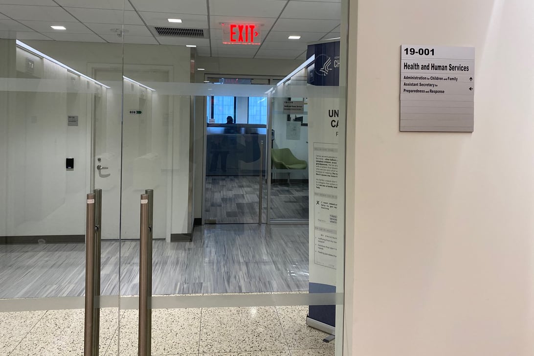 The view through glass doors shows an empty office.