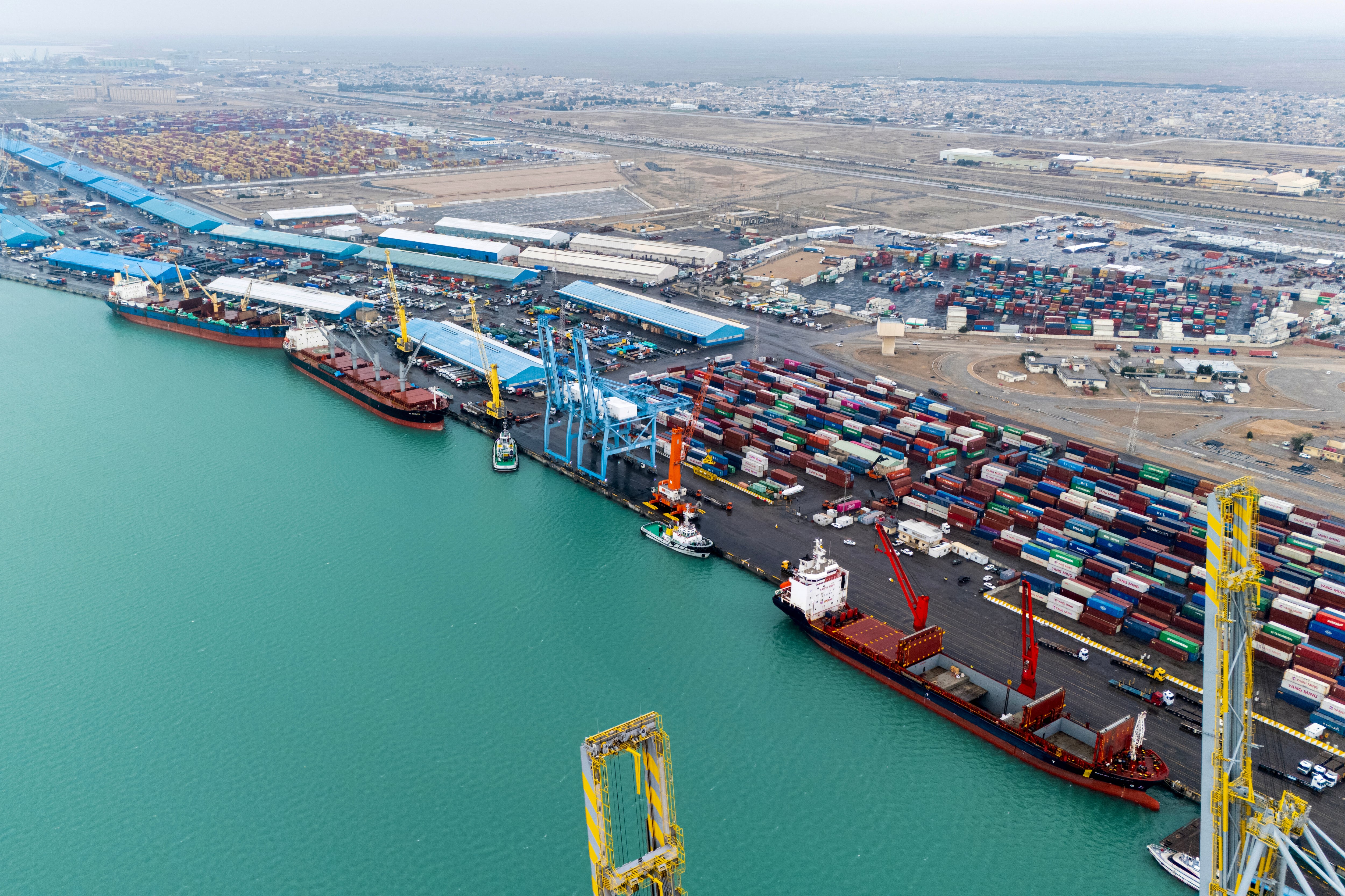 Shipping containers are stacked at a port.
