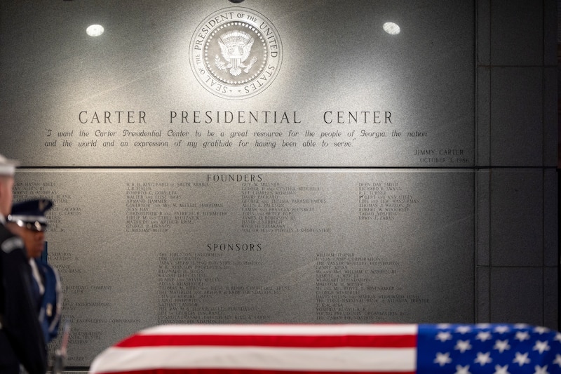 Jimmy Carter's flag-draped coffin rests at the Carter Presidential Library and Museum.