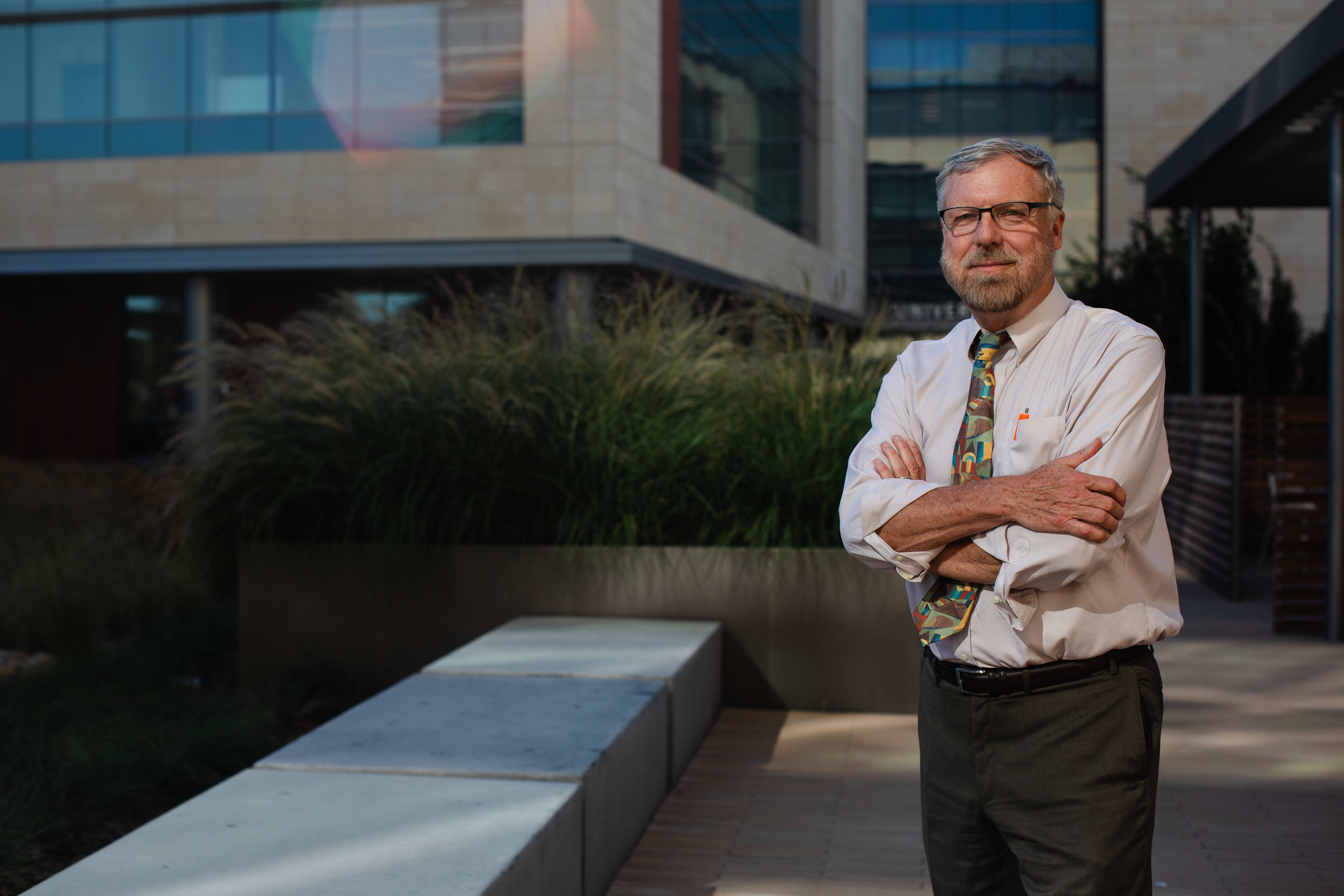 Dr. Elliott Main stands outside a building.