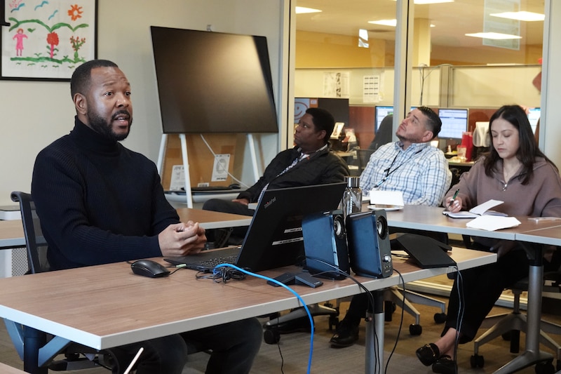 A man addresses health workers about patient rights in a classroom setting.