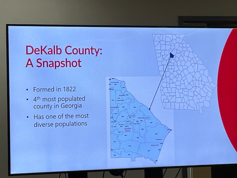 A presentation on a screen shows an annotated map of DeKalb County, Georgia.