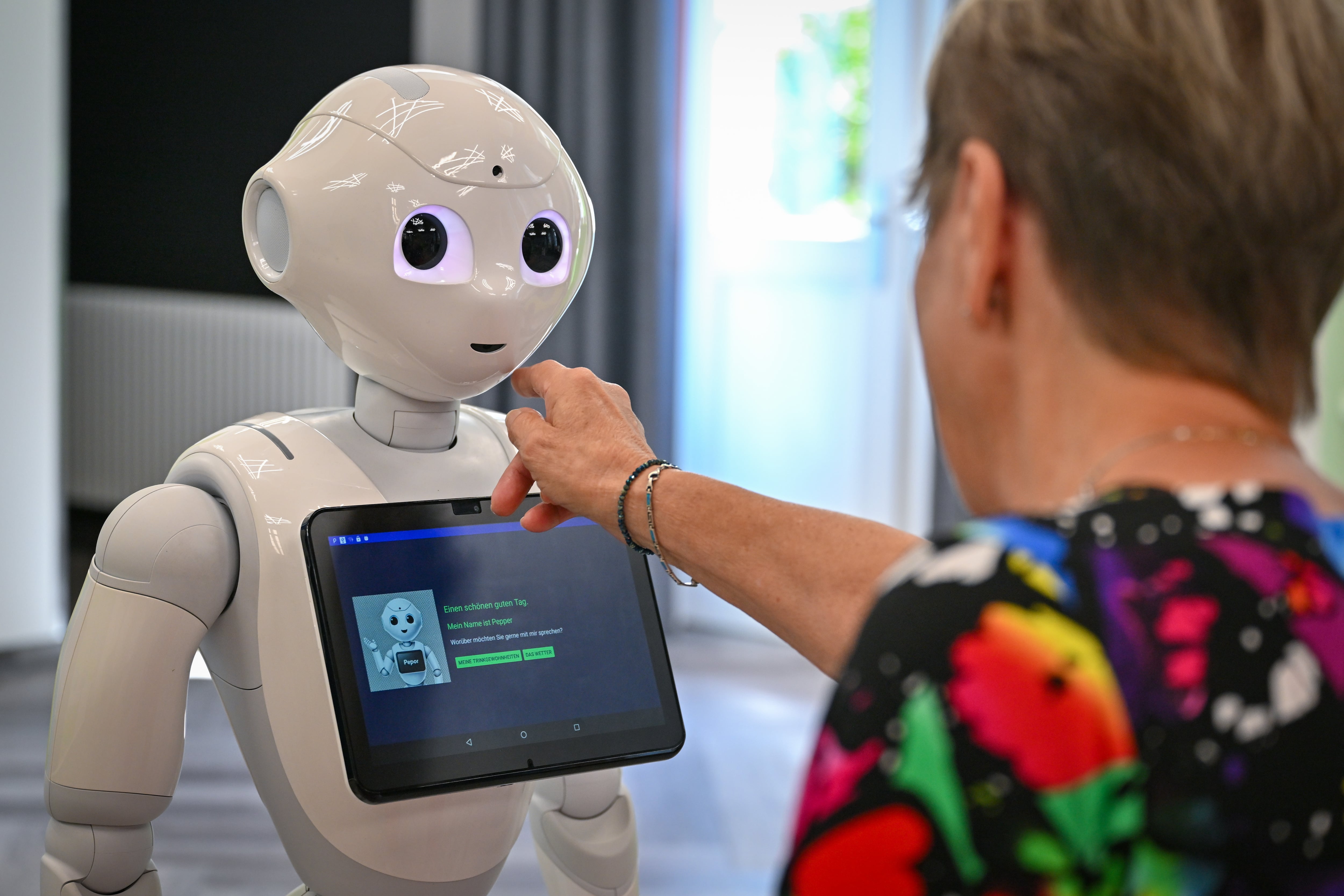 A person interacts with a robot.