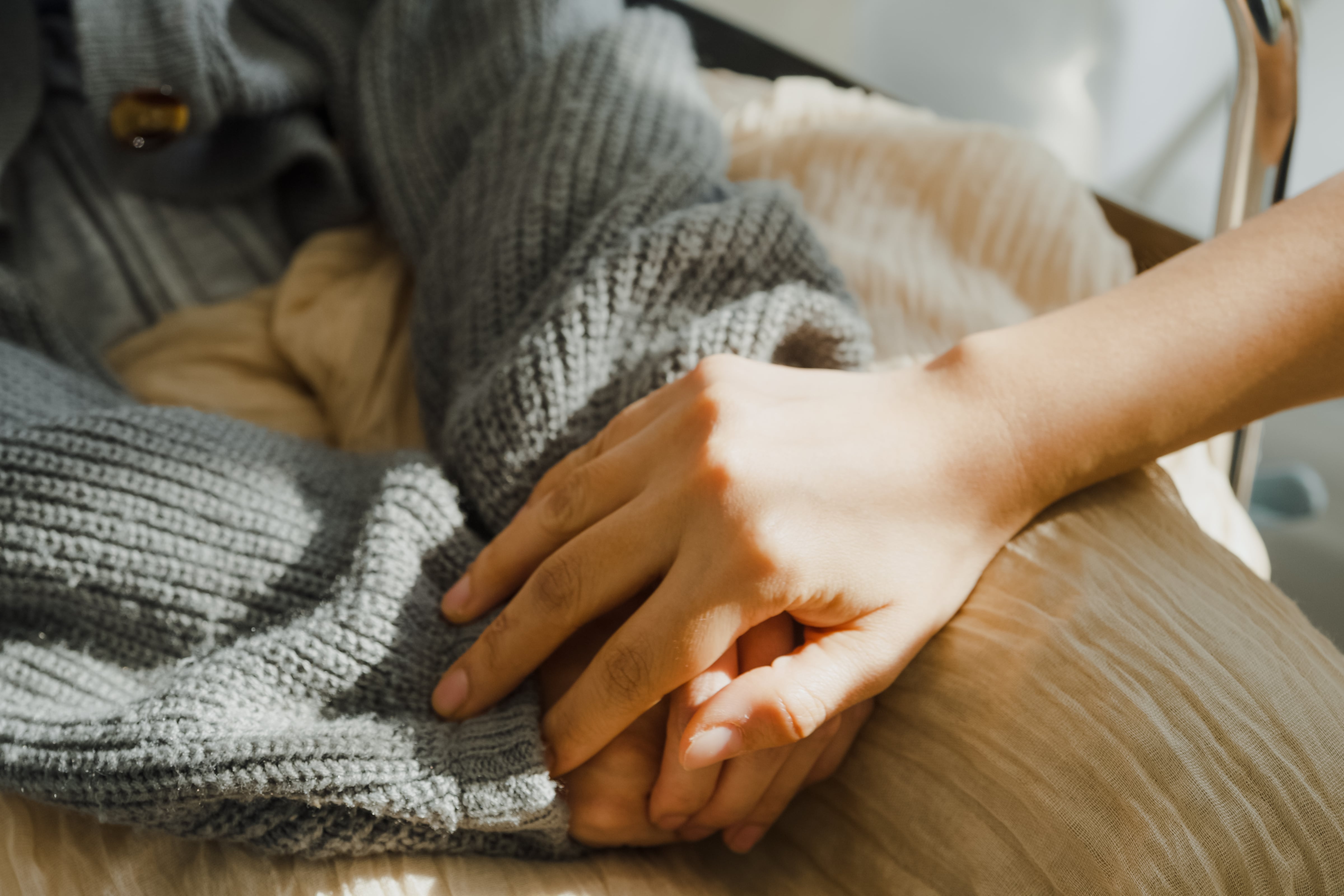 Two people hold hands.