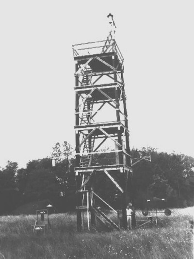 This historic image shows a wooden tower used in counting mosquitoes.