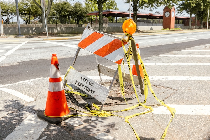 A barricade covers a pothole in a crosswalk in East Point, Georgia.