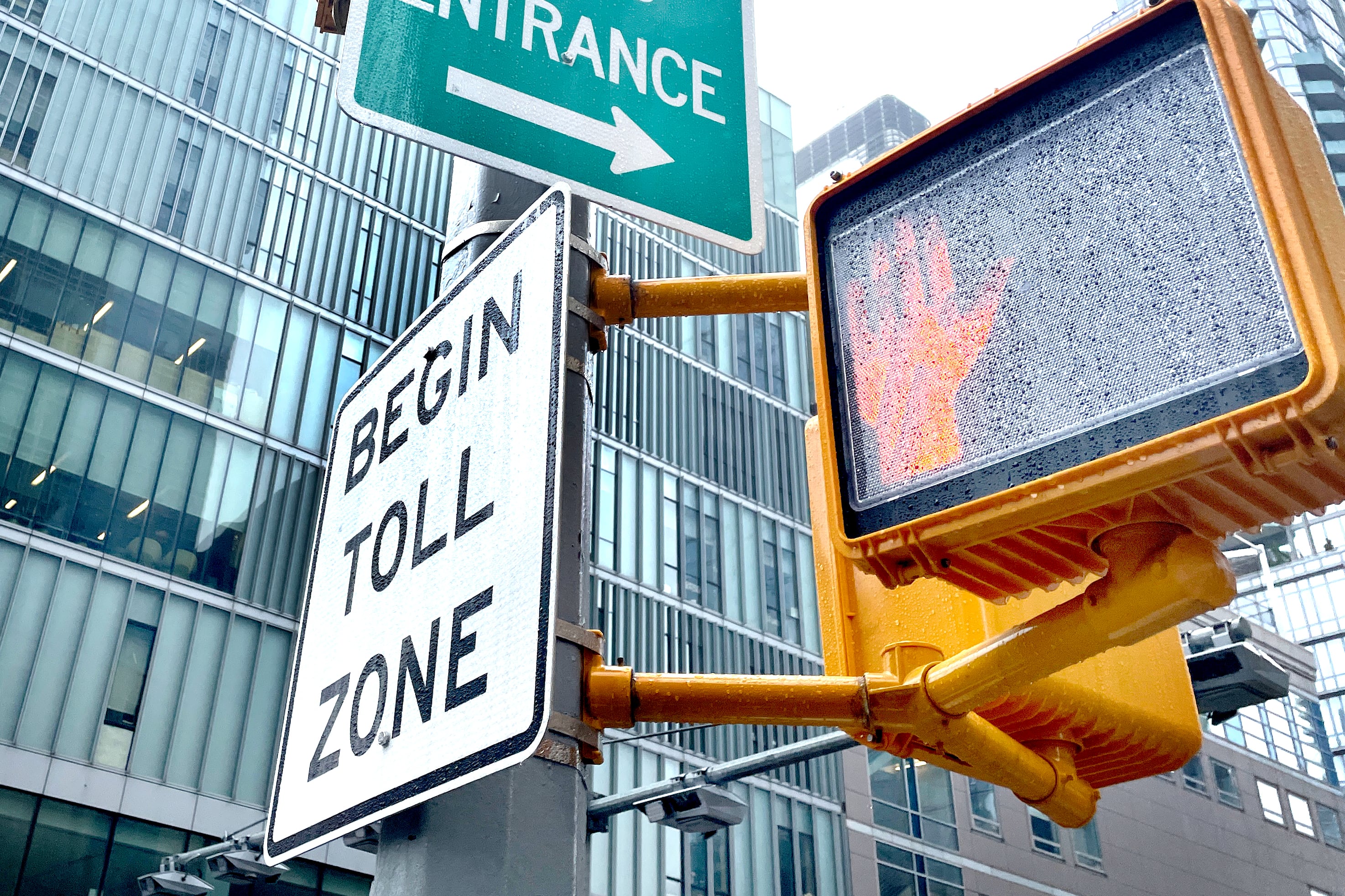 Signs on a New York City street make start of toll zone and point to the entrance of the Congestion Relief Zone.