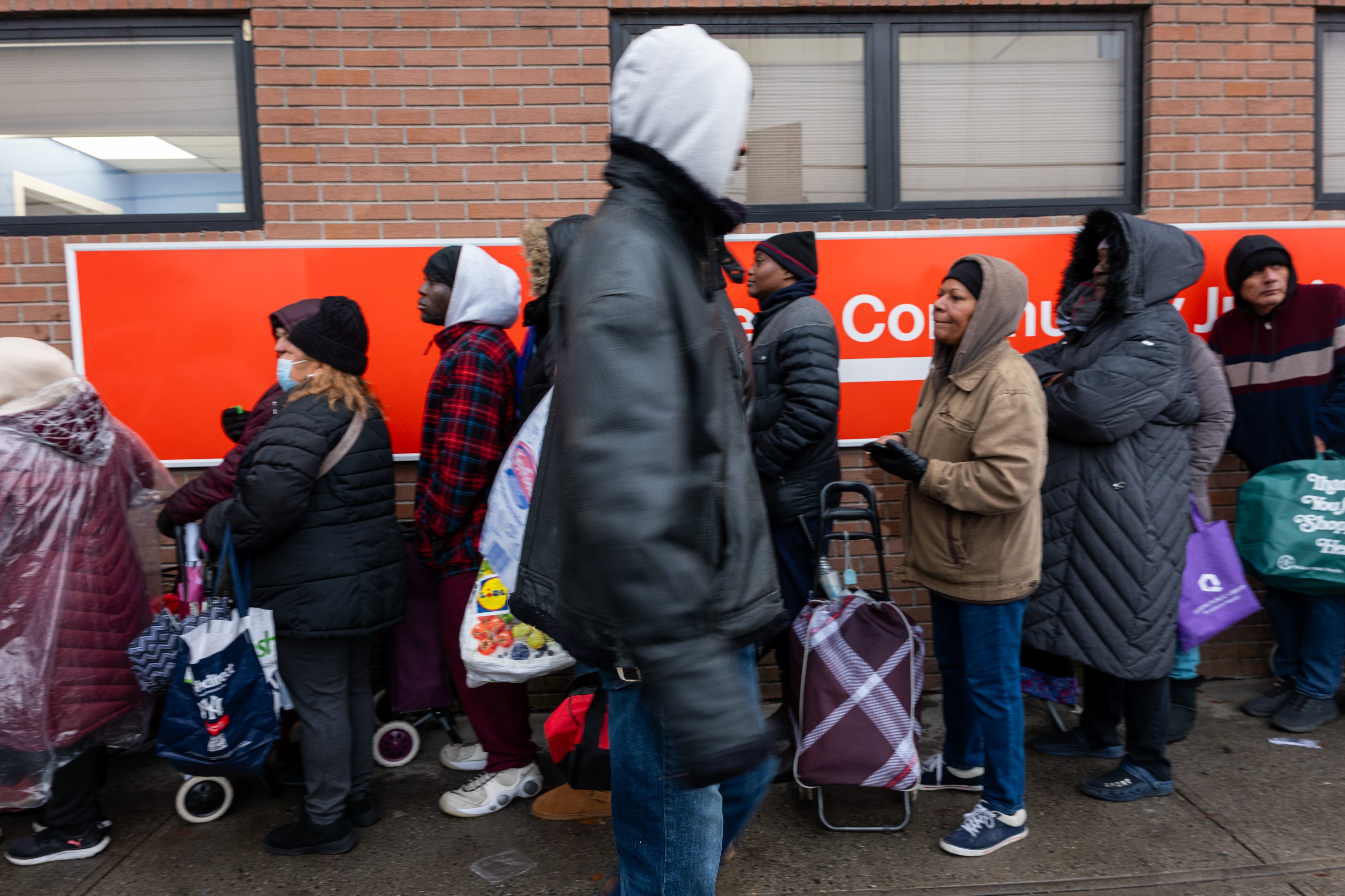 People wait in line to receive a Thanksgiving turkey.