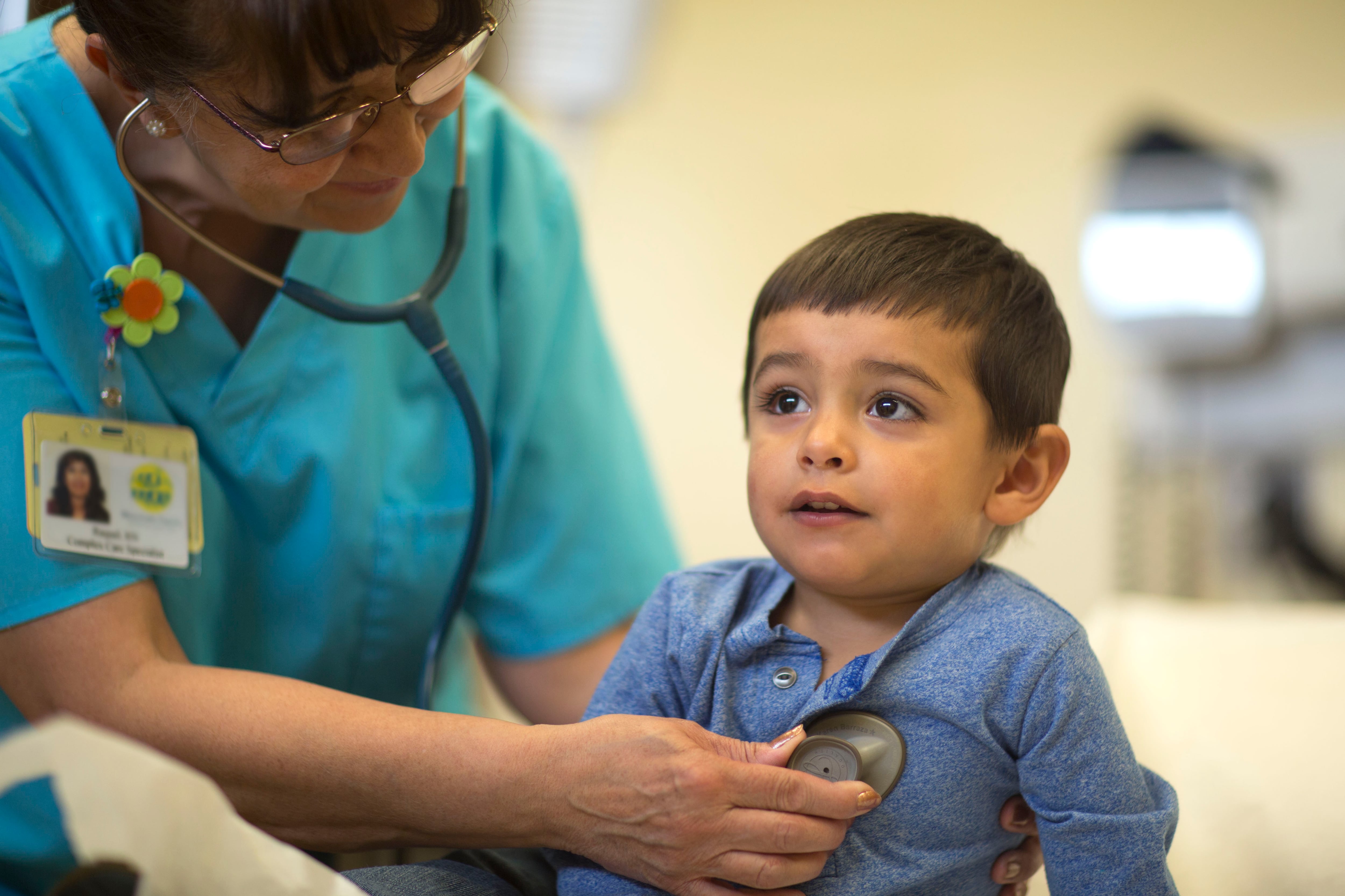 A young boy has his heart rhythm checked in a doctor's office.