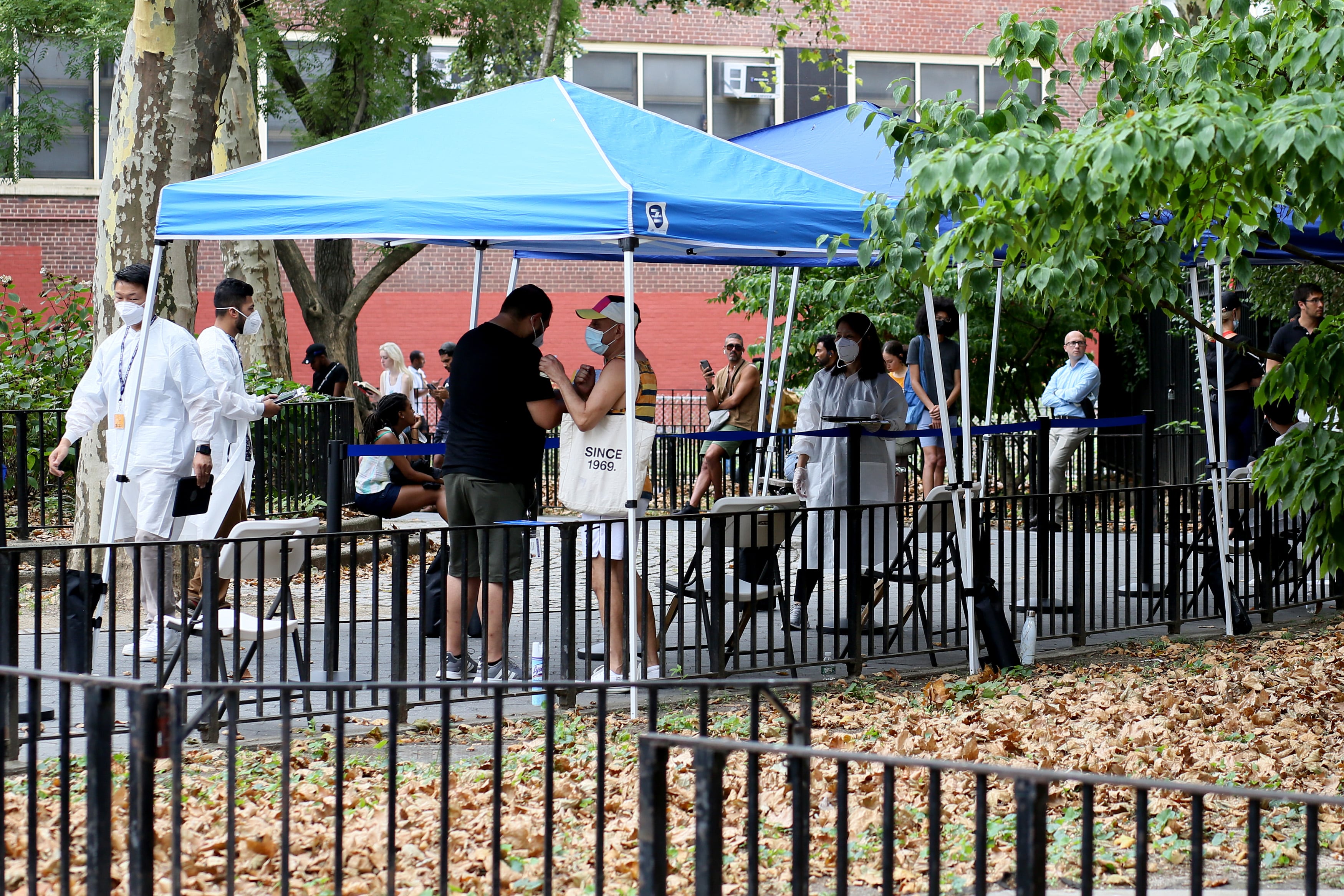People line up at a tent to get an mpox vaccine.