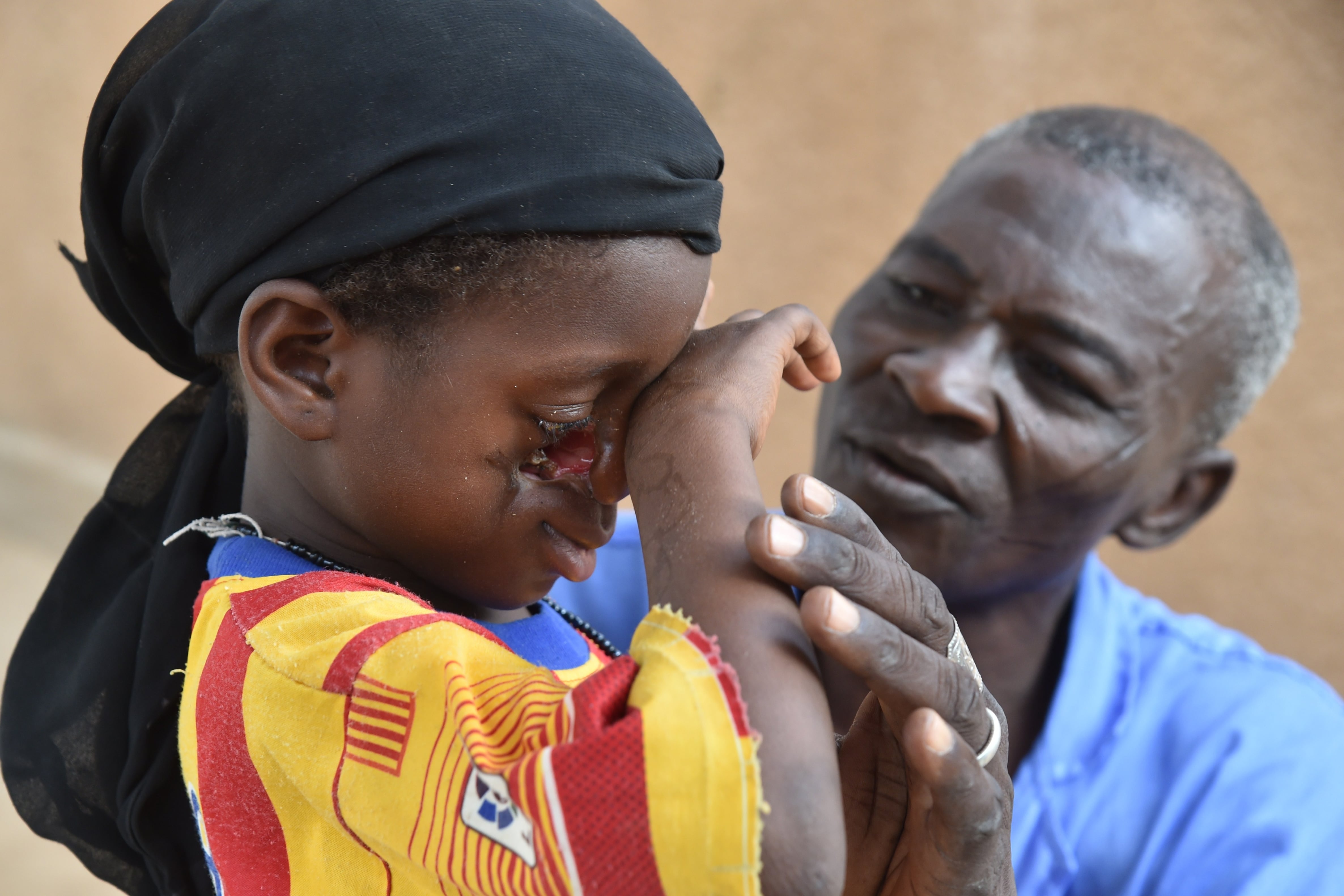 A health worker tends to a young girl.