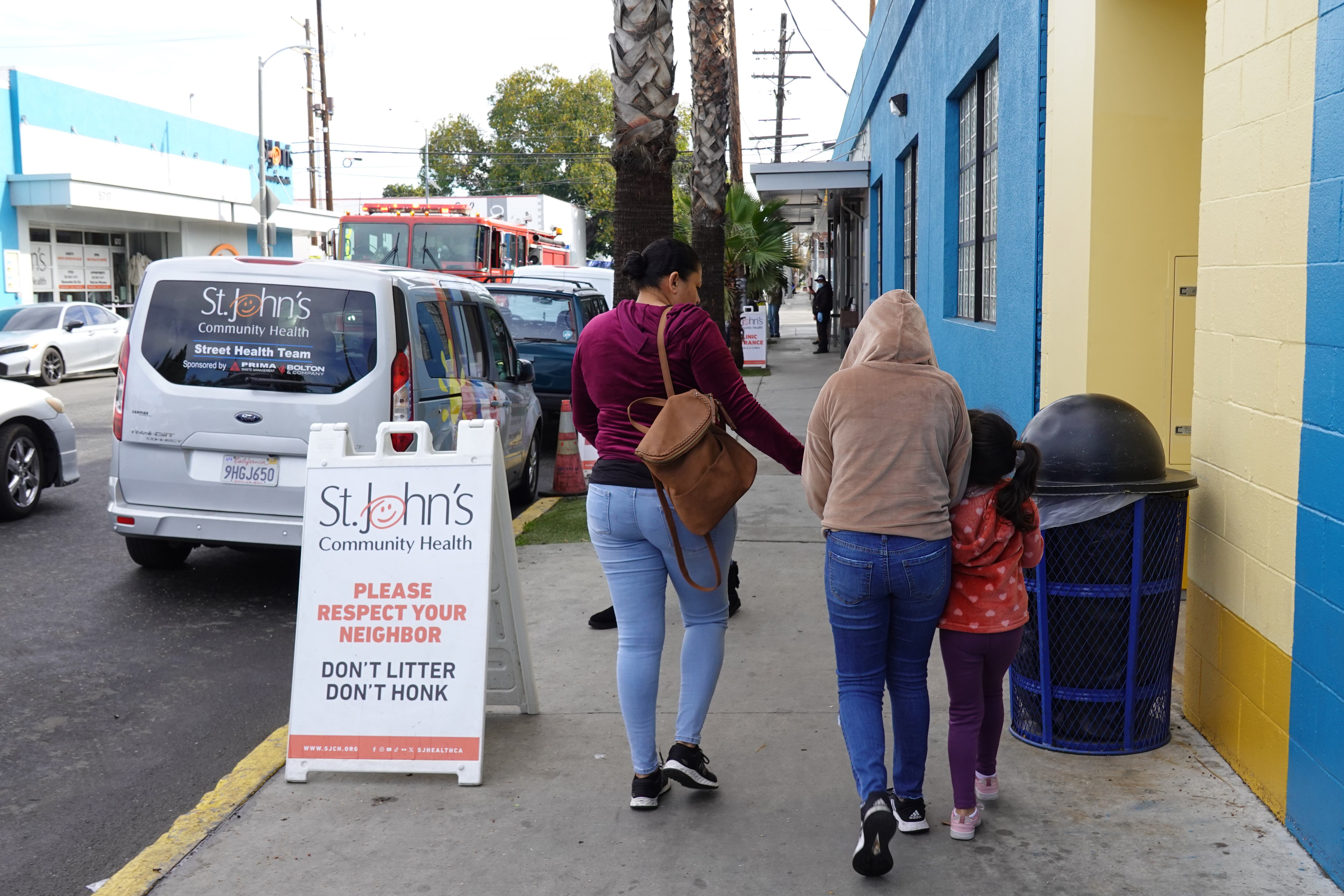 A family walks outside a health clinic.