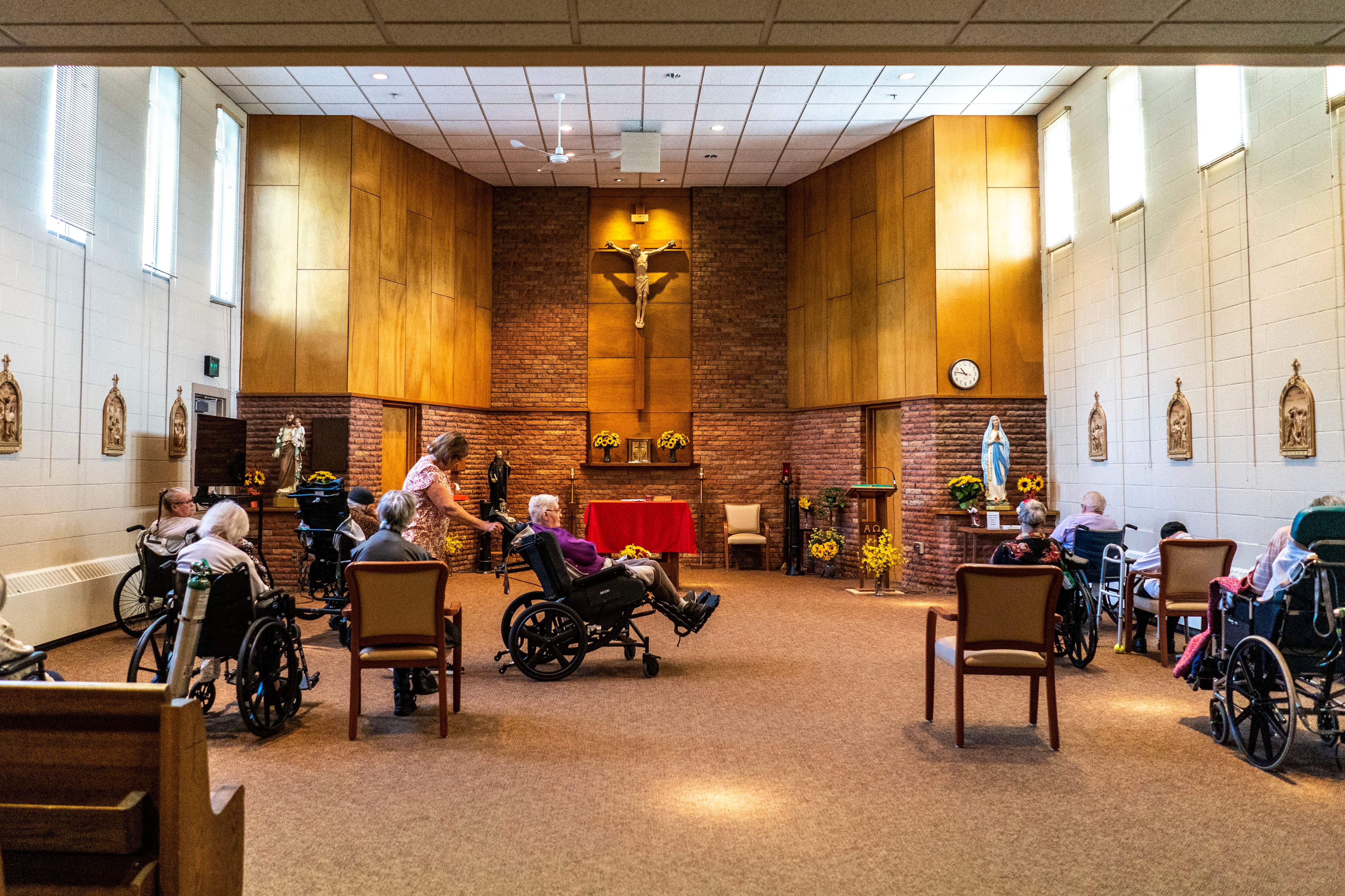 Residents are rolled in the chapel before afternoon mass at a nursing home.