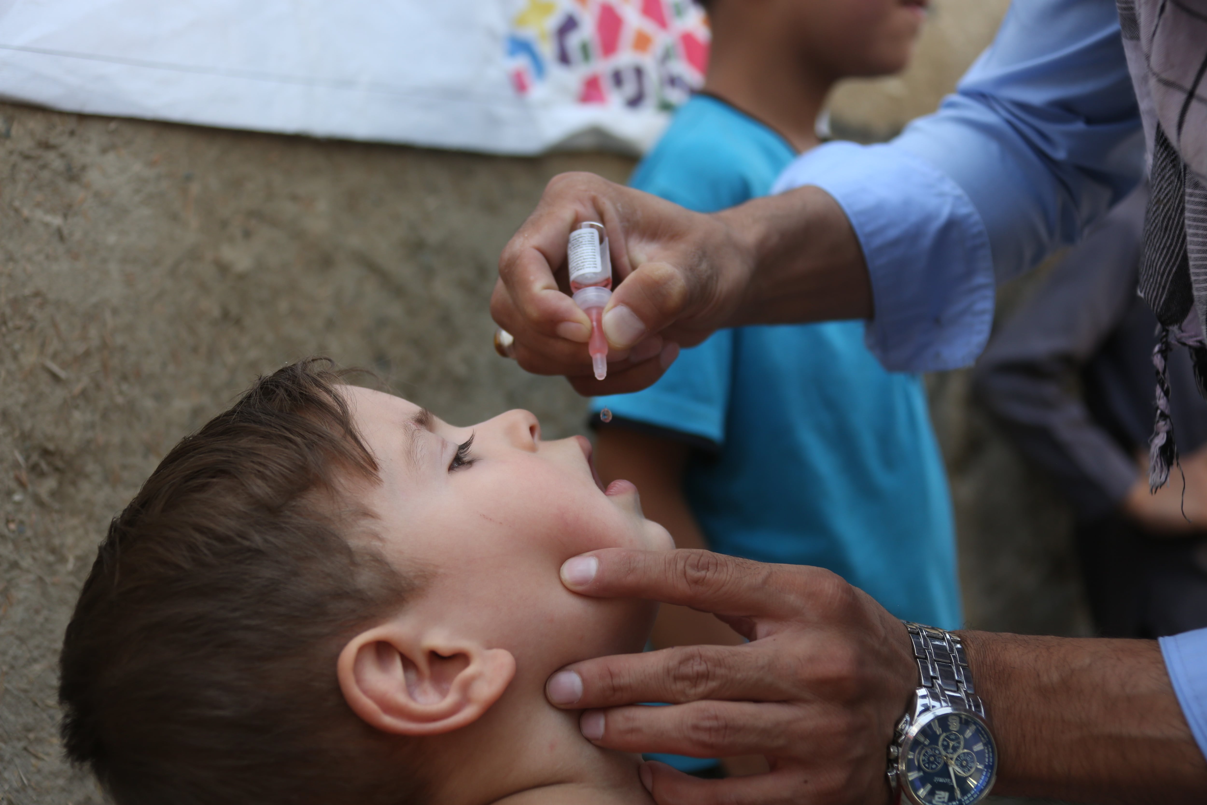 A child is given a polio vaccine.