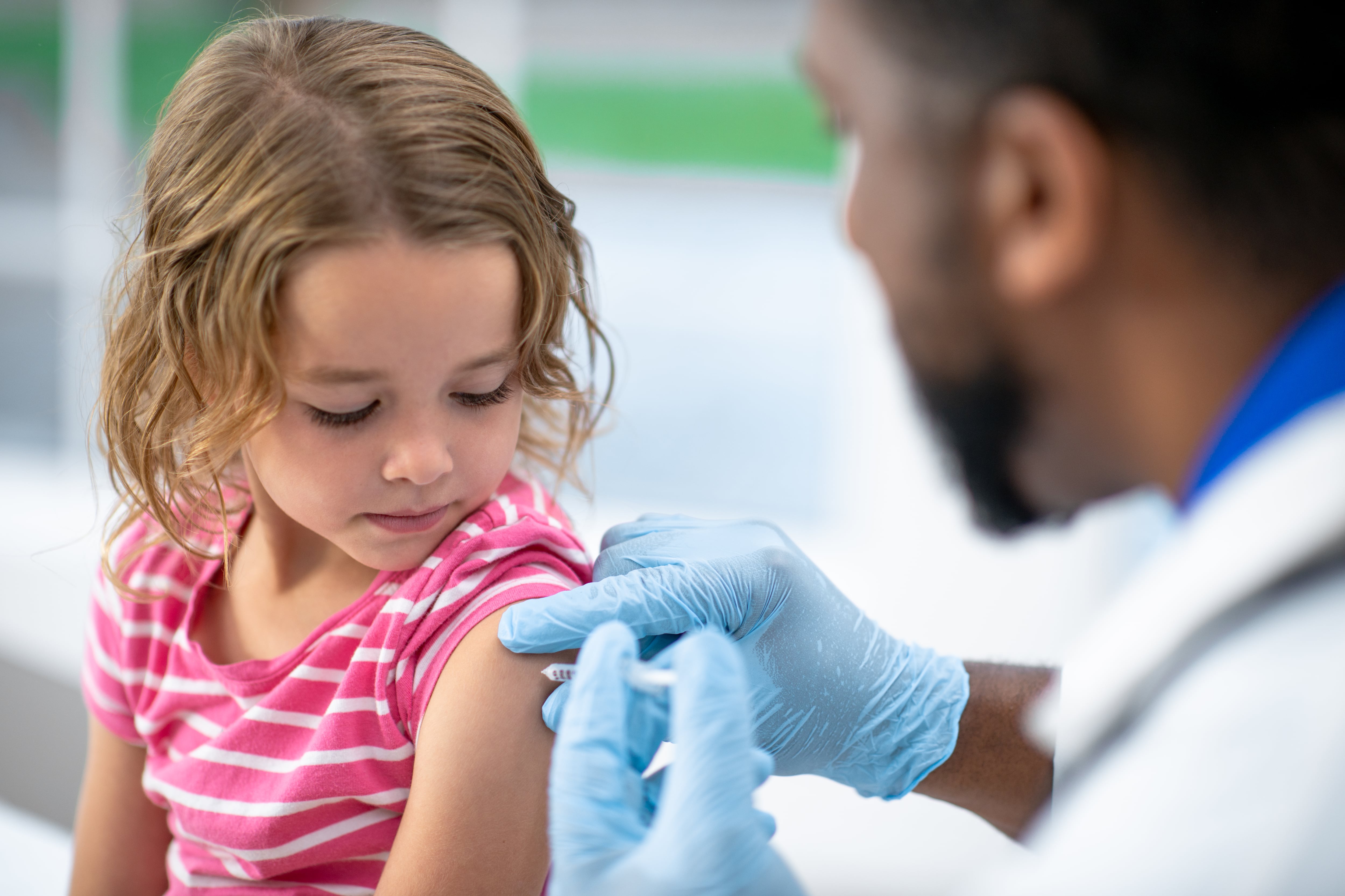 A child gets a shot in the arm.
