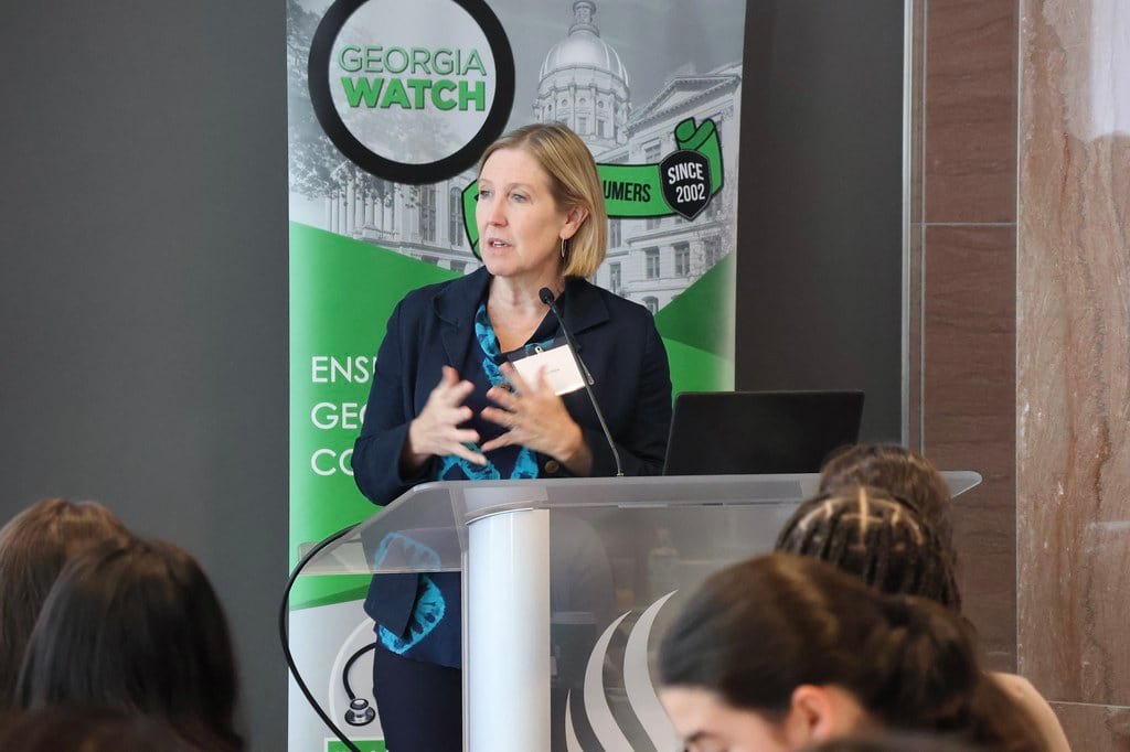 Sarah Blake speaks from a podium.