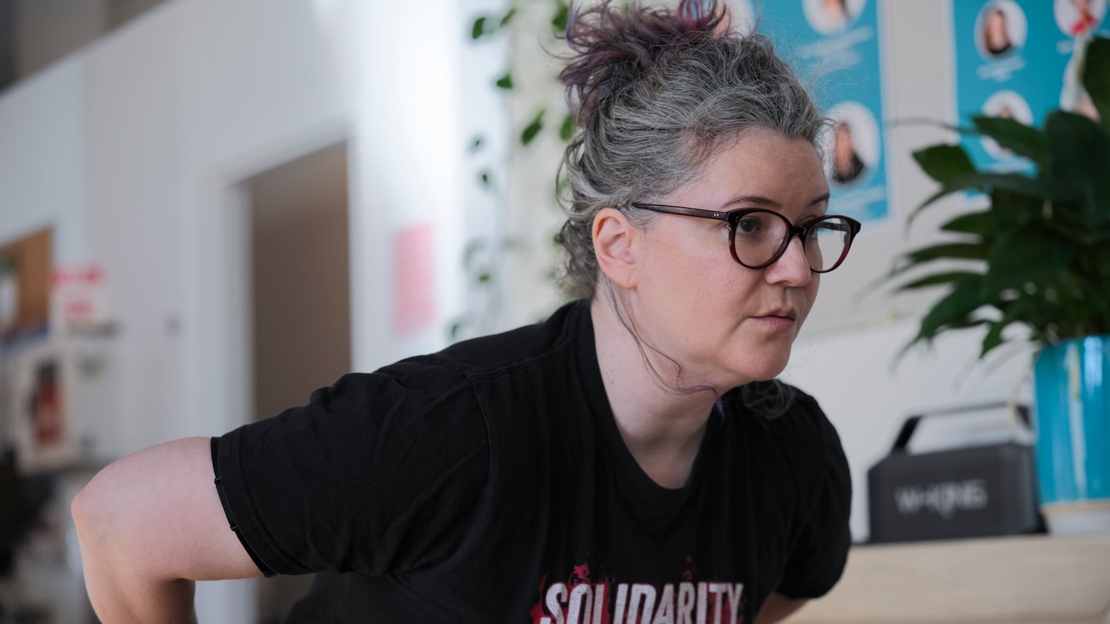 A photograph of a white woman doing a squat.