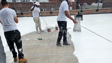 Flat, dark rooftops trap heat. NYC program aims to cool more buildings with free reflective coating.