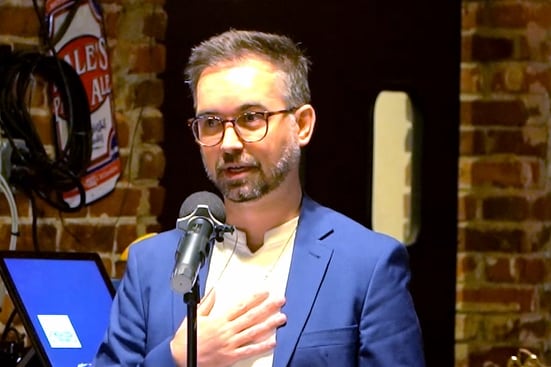 Brandon Kenemer speaks at a microphone.